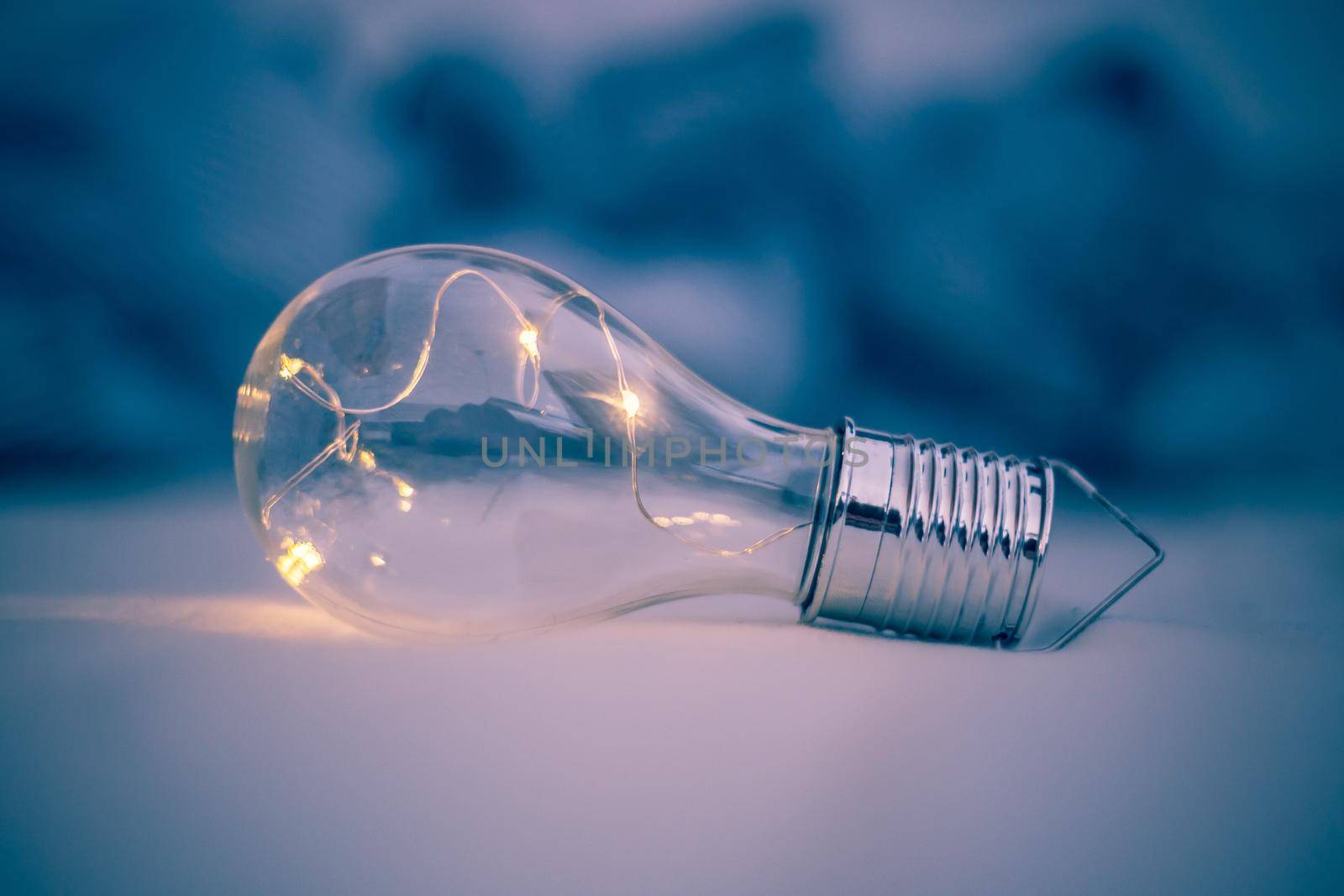 LED light bulb is lying in the bed. Symbol for ideas and innovation.