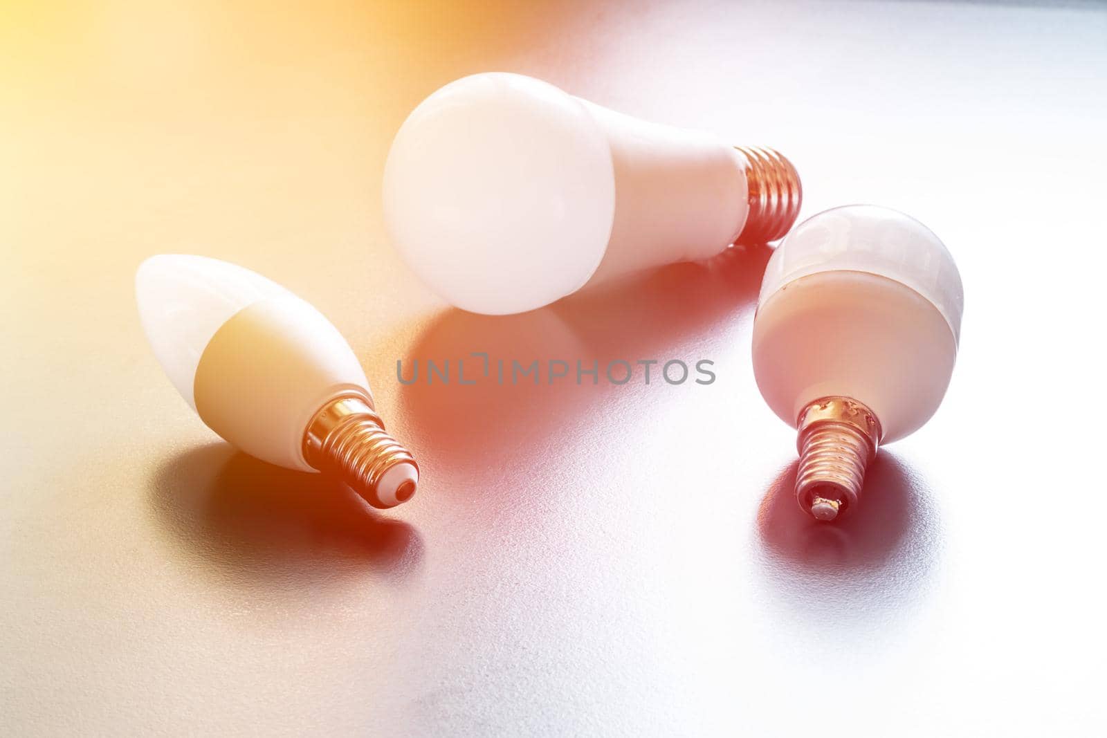 White light bulb lying on a desk, concept for ideas. Sunlight.