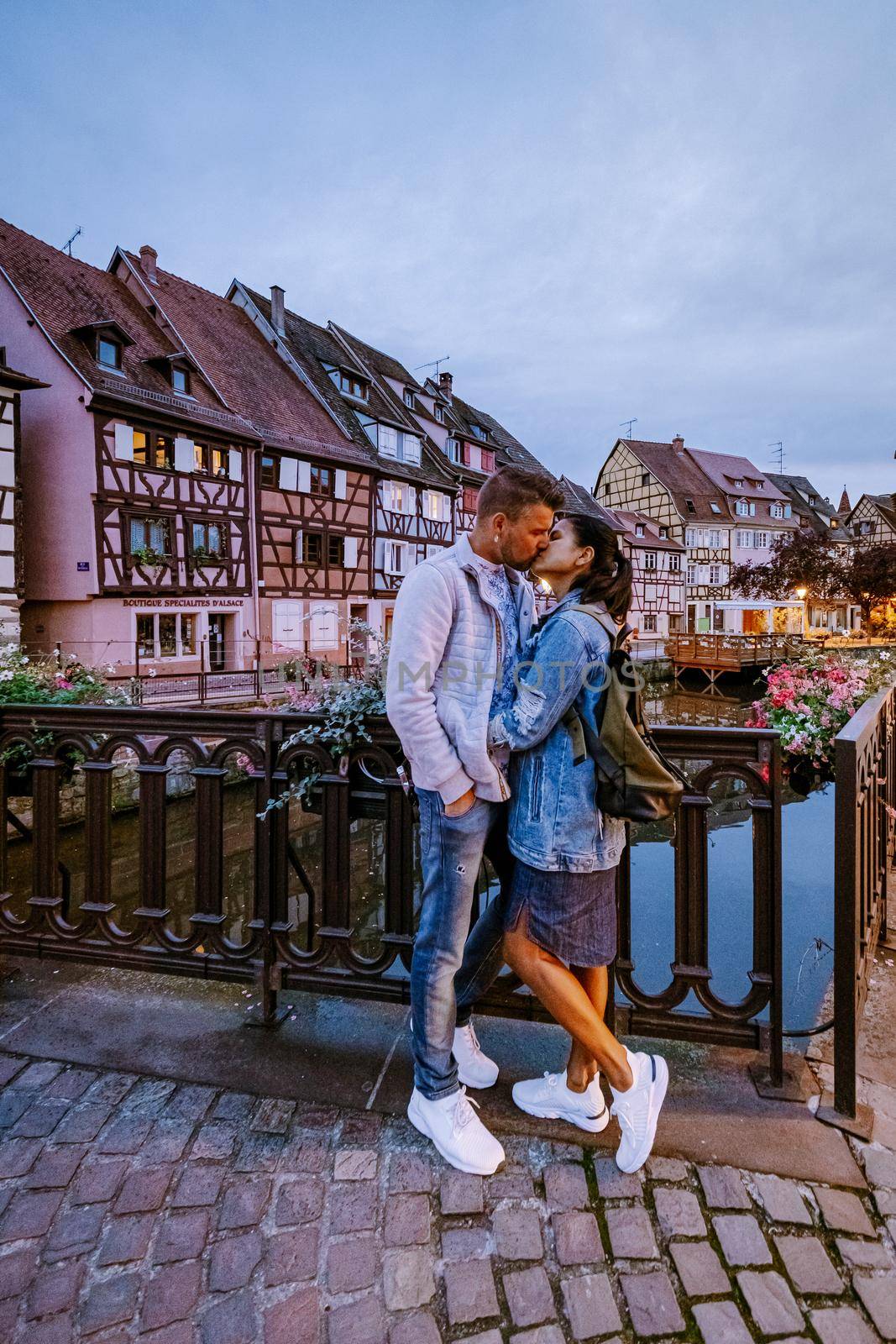 couple on city trip Colmar, Alsace, France. Petite Venice, water canal and traditional half timbered houses. Colmar is a charming town in Alsace, France. Beautiful view of colorful romantic city Colmar