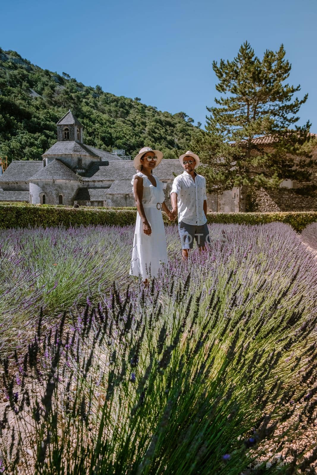 couple visit the old town of Gordes Provence,Blooming purple lavender fields at Senanque monastery, Provence, southern France. Europe
