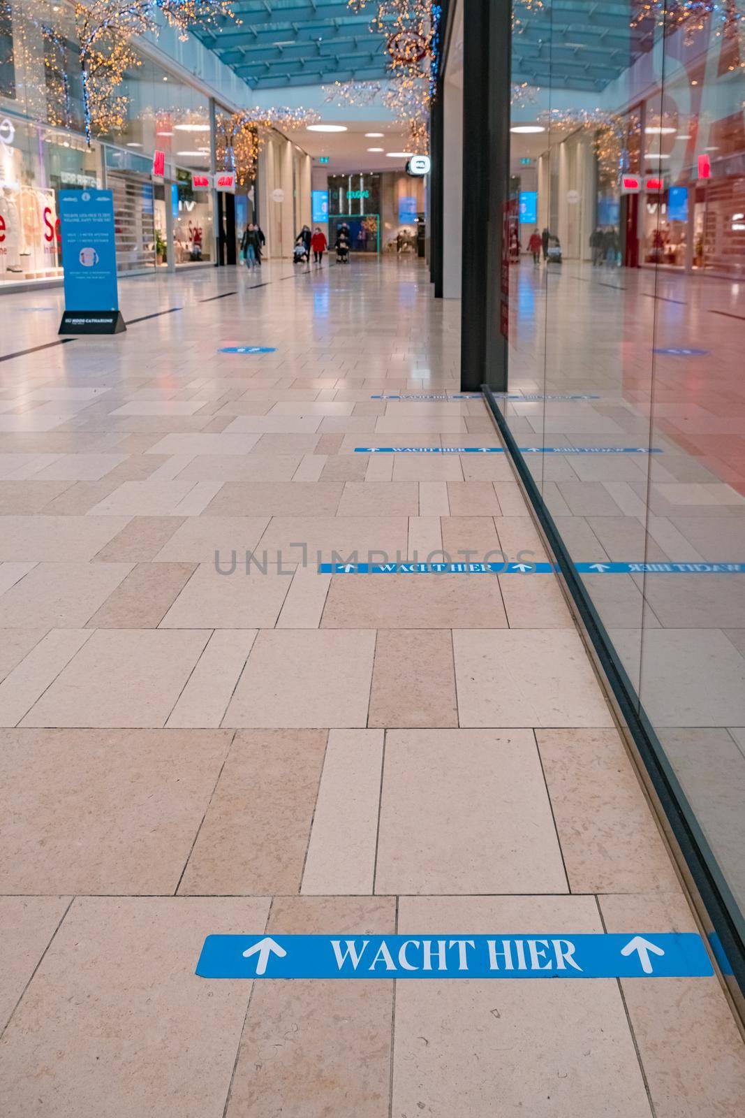 Utrecht, The Netherlands January 2021 - empty shopping mall during the lockdown in the Netherlands Hoog Catherijne shopping mall in the center of town during the covid pandemic with social distance signs on the floor. Holland