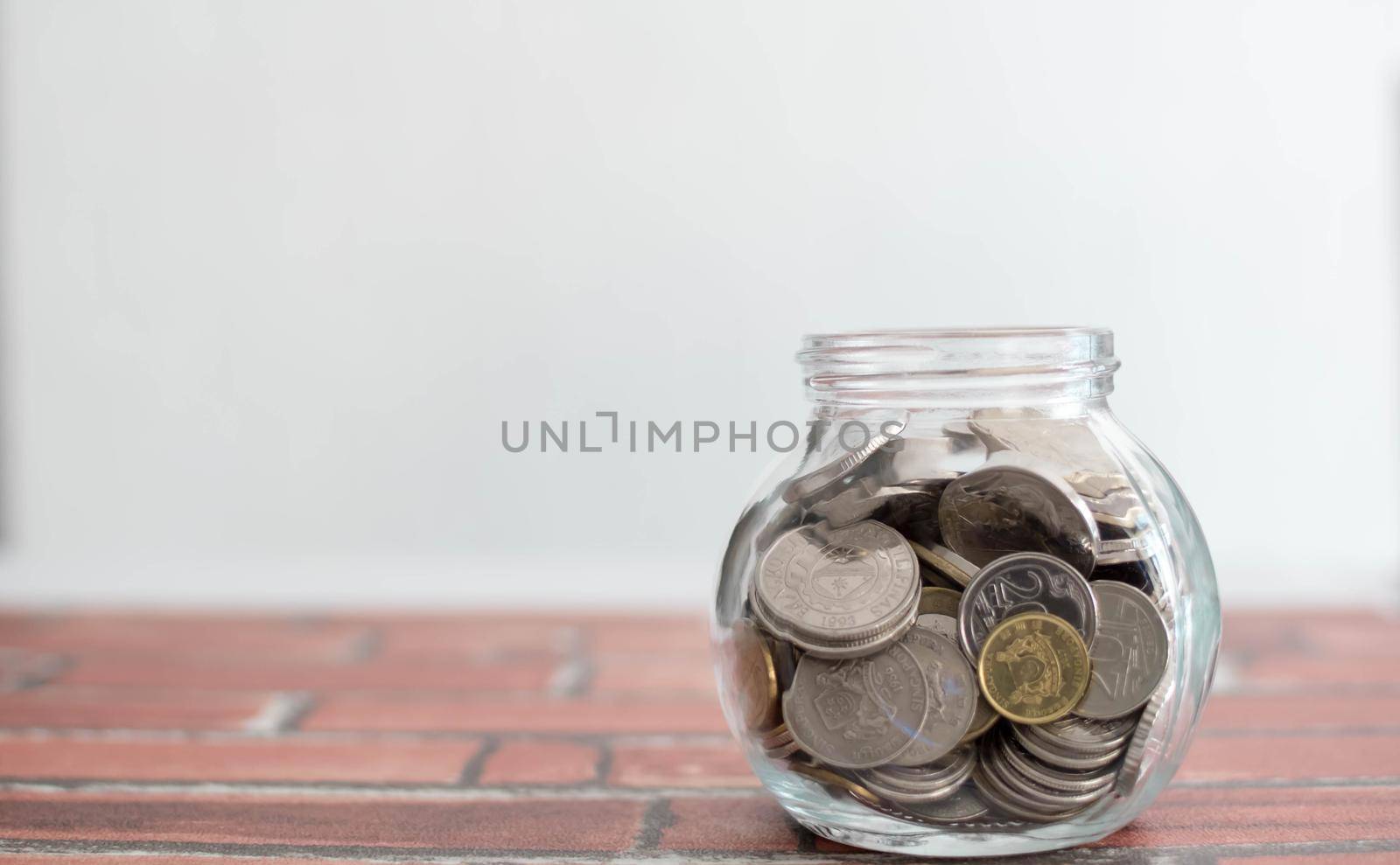 Saving money for a good future for business and for family. Coins inside a jar. Money and coins inside a jar