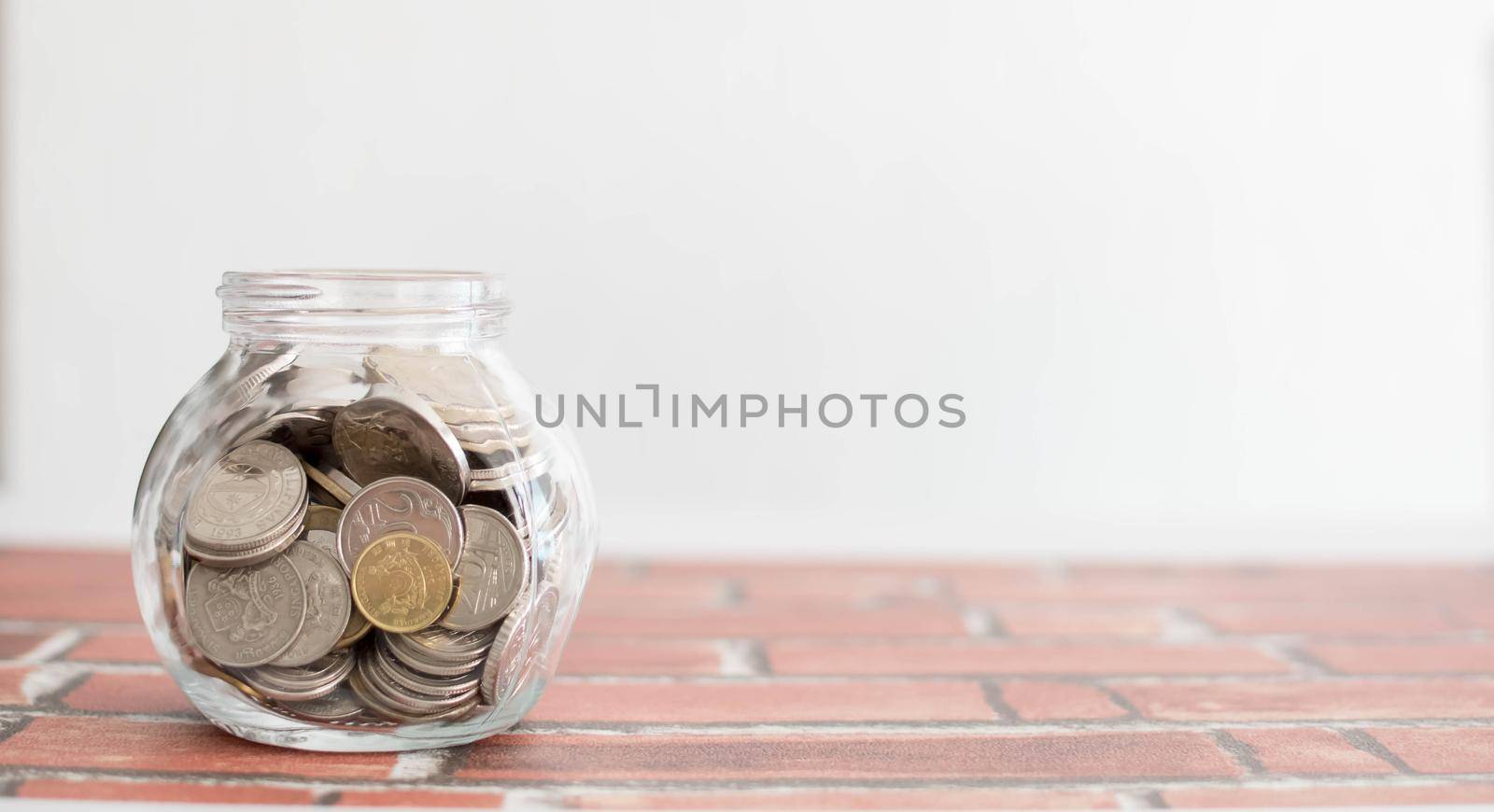 Saving money for a good future for business and for family. Coins inside a jar. Money and coins inside a jar