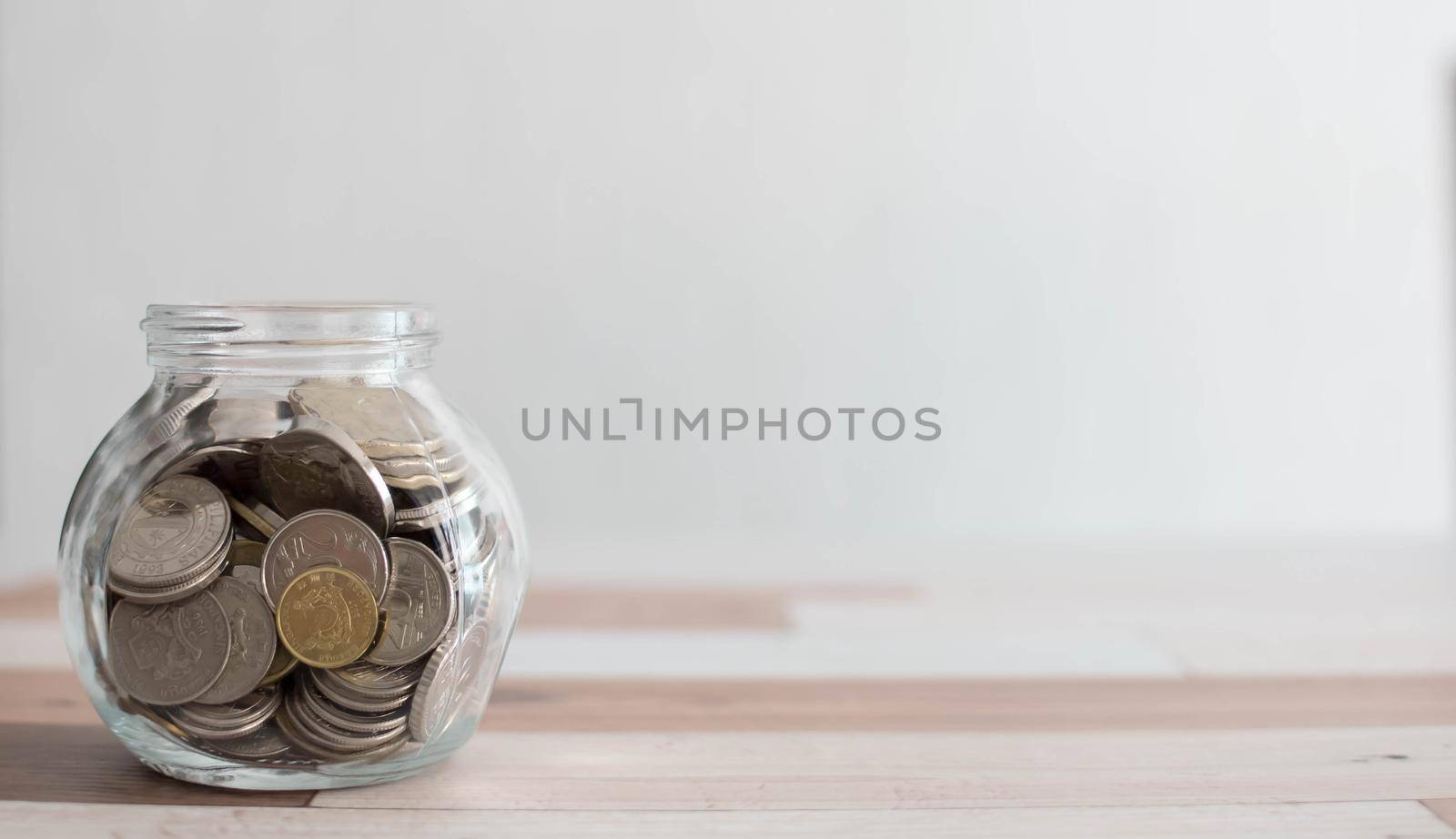 Saving money for a good future for business and for family. Coins inside a jar. Money and coins inside a jar