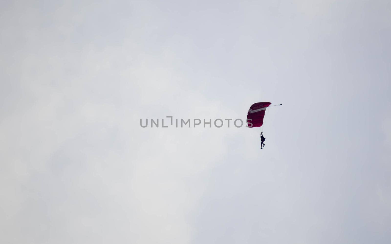 silhouette parachute stunt unfocused and blurry while gliding in the air by billroque