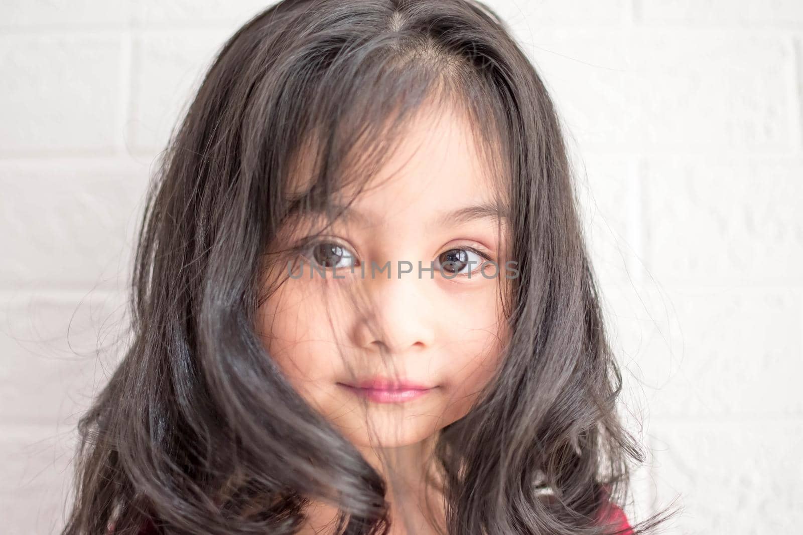 Fashion model and beauty look. Stylish girl with pretty face on grey background. Hairdresser, skincare, casual style. Beauty and kid fashion with healthy hair. Little girl with long hair. by billroque