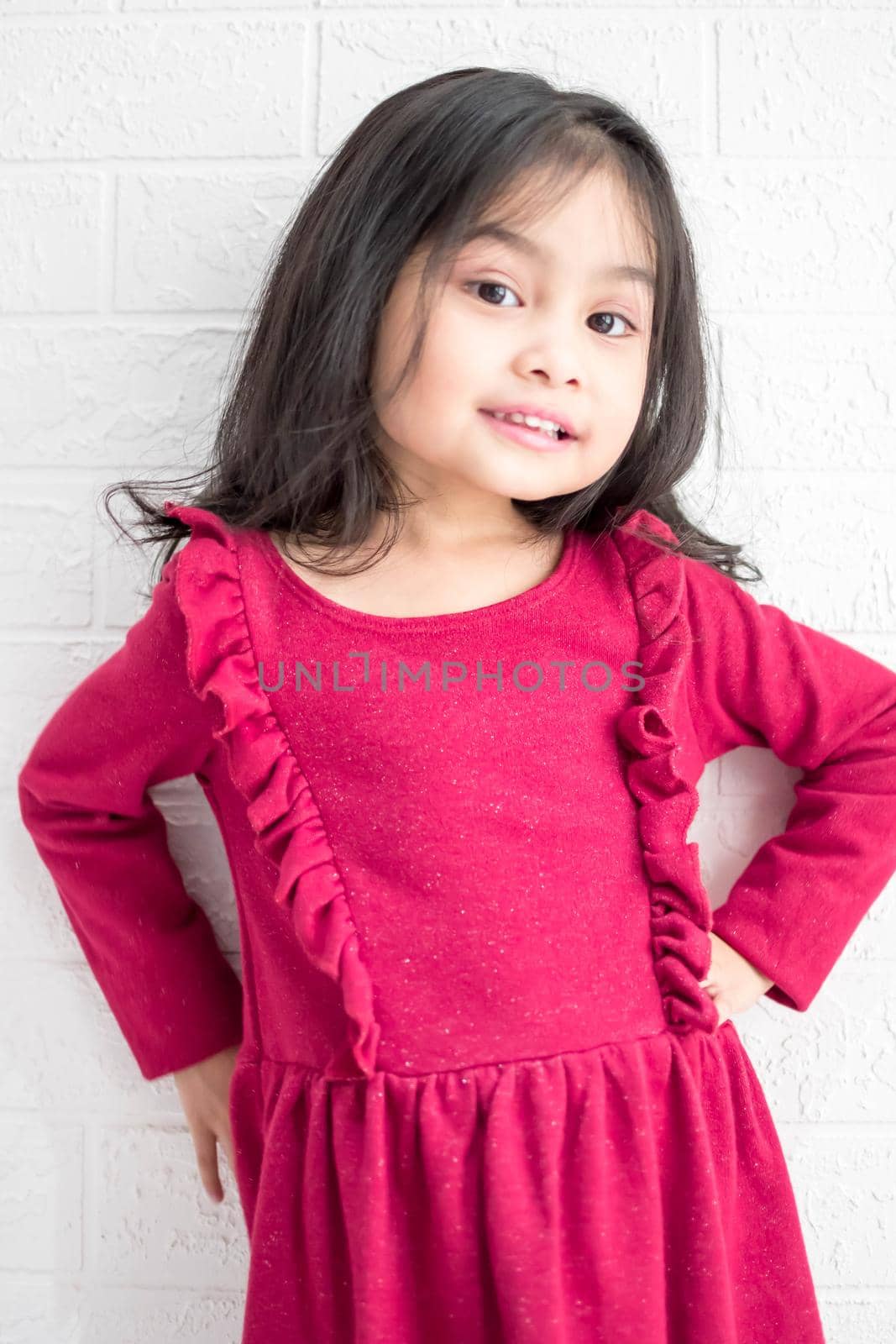 A Fashion model and beauty look. Stylish girl with pretty face on grey background. Hairdresser, skincare, casual style. Beauty and kid fashion with healthy hair. Little girl with long hair.