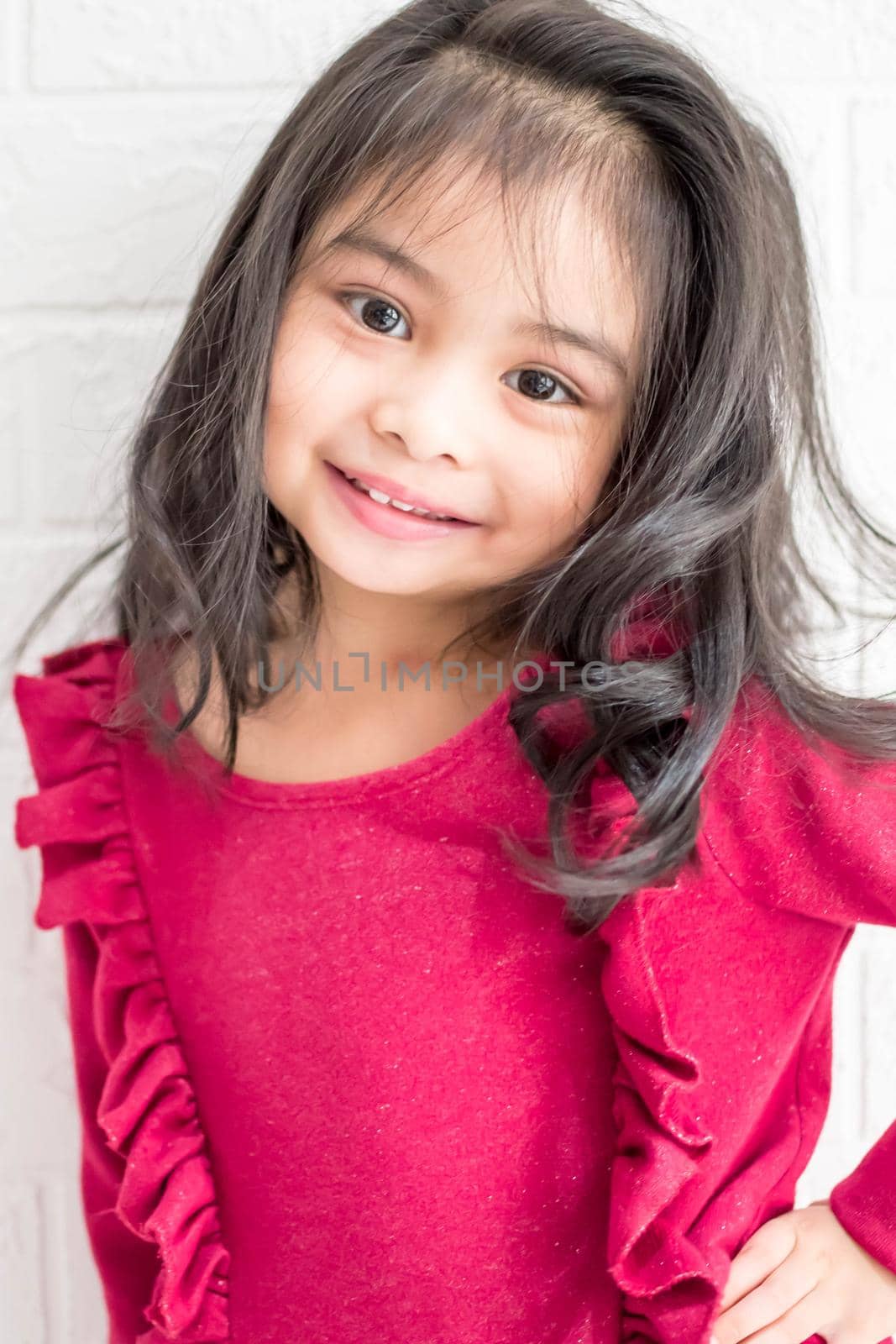 A Fashion model and beauty look. Stylish girl with pretty face on grey background. Hairdresser, skincare, casual style. Beauty and kid fashion with healthy hair. Little girl with long hair.