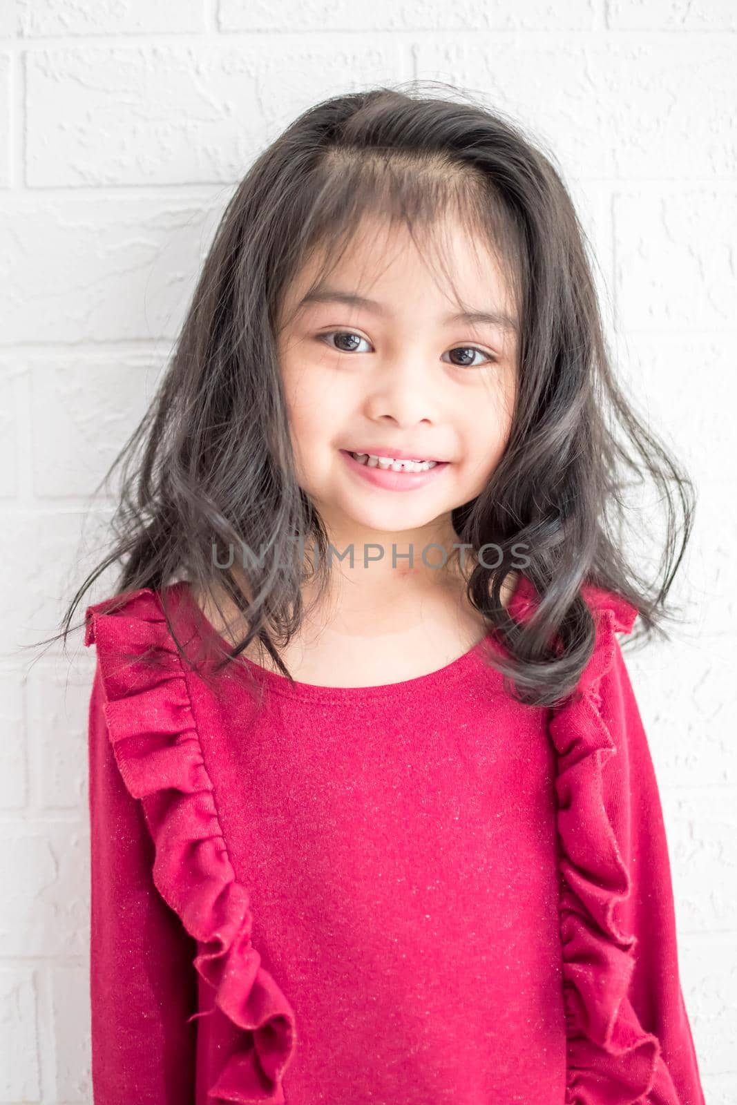 A Fashion model and beauty look. Stylish girl with pretty face on grey background. Hairdresser, skincare, casual style. Beauty and kid fashion with healthy hair. Little girl with long hair.