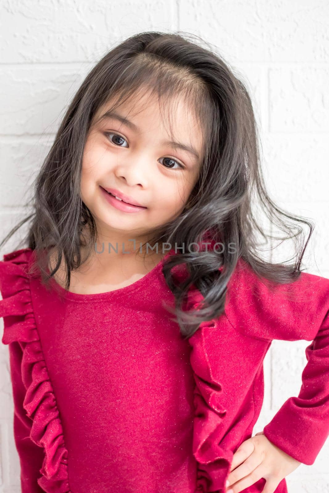 A Fashion model and beauty look. Stylish girl with pretty face on grey background. Hairdresser, skincare, casual style. Beauty and kid fashion with healthy hair. Little girl with long hair.