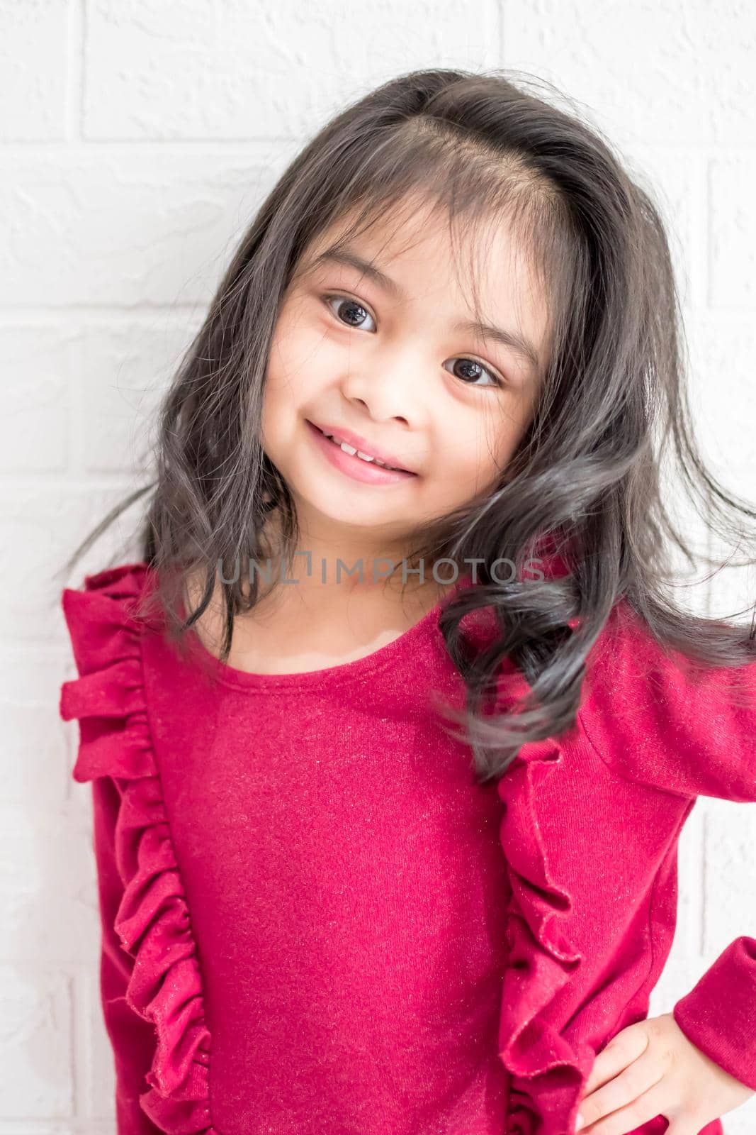 A Fashion model and beauty look. Stylish girl with pretty face on grey background. Hairdresser, skincare, casual style. Beauty and kid fashion with healthy hair. Little girl with long hair.