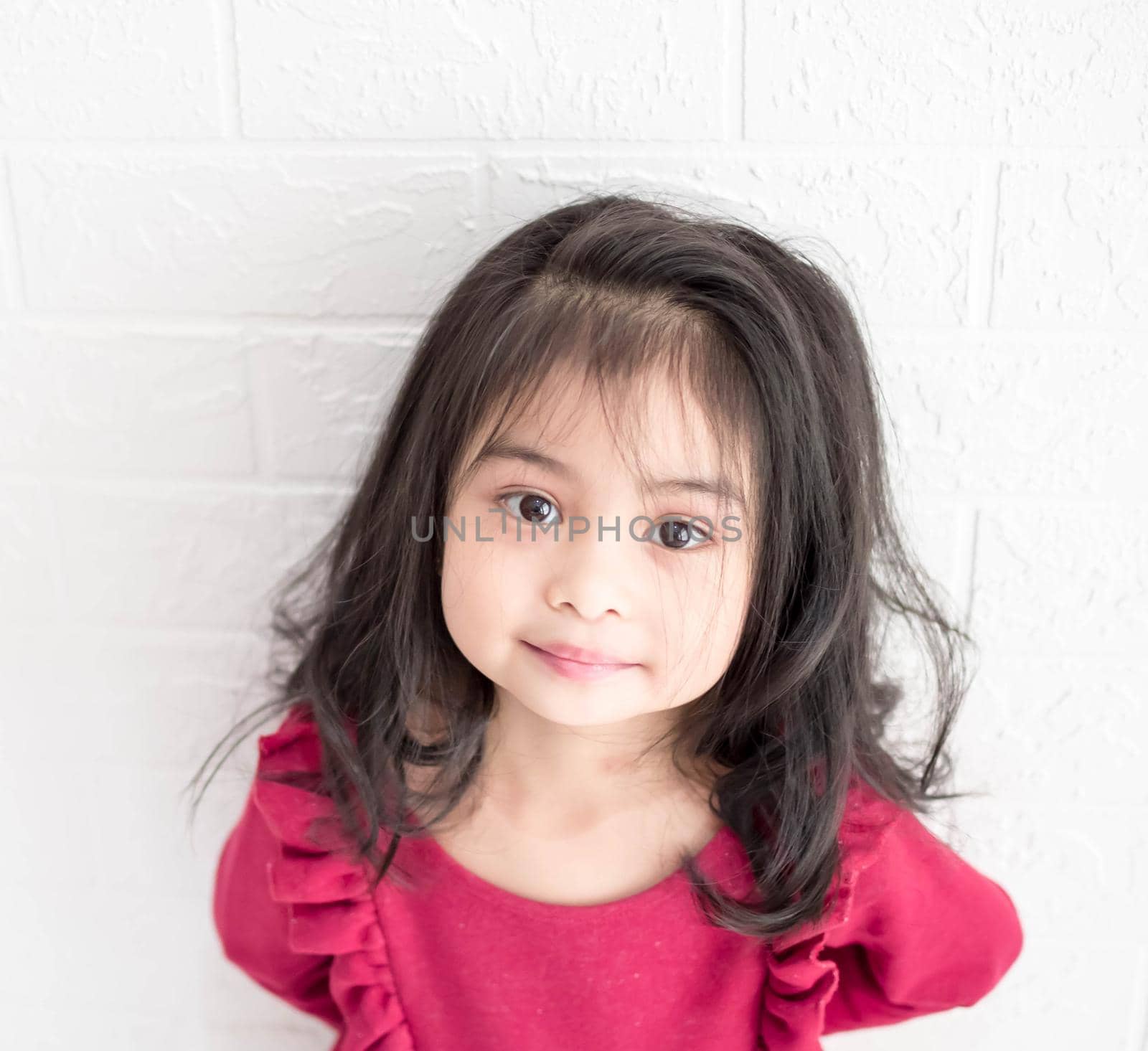 A Fashion model and beauty look. Stylish girl with pretty face on grey background. Hairdresser, skincare, casual style. Beauty and kid fashion with healthy hair. Little girl with long hair.