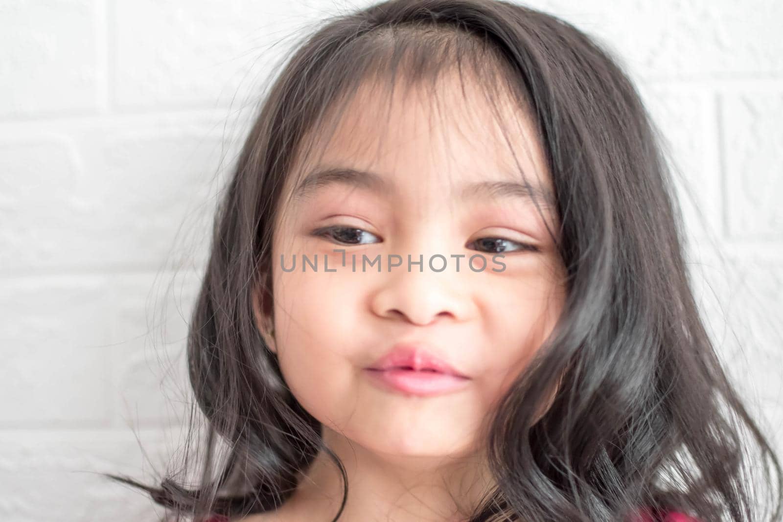 A Fashion model and beauty look. Stylish girl with pretty face on grey background. Hairdresser, skincare, casual style. Beauty and kid fashion with healthy hair. Little girl with long hair.