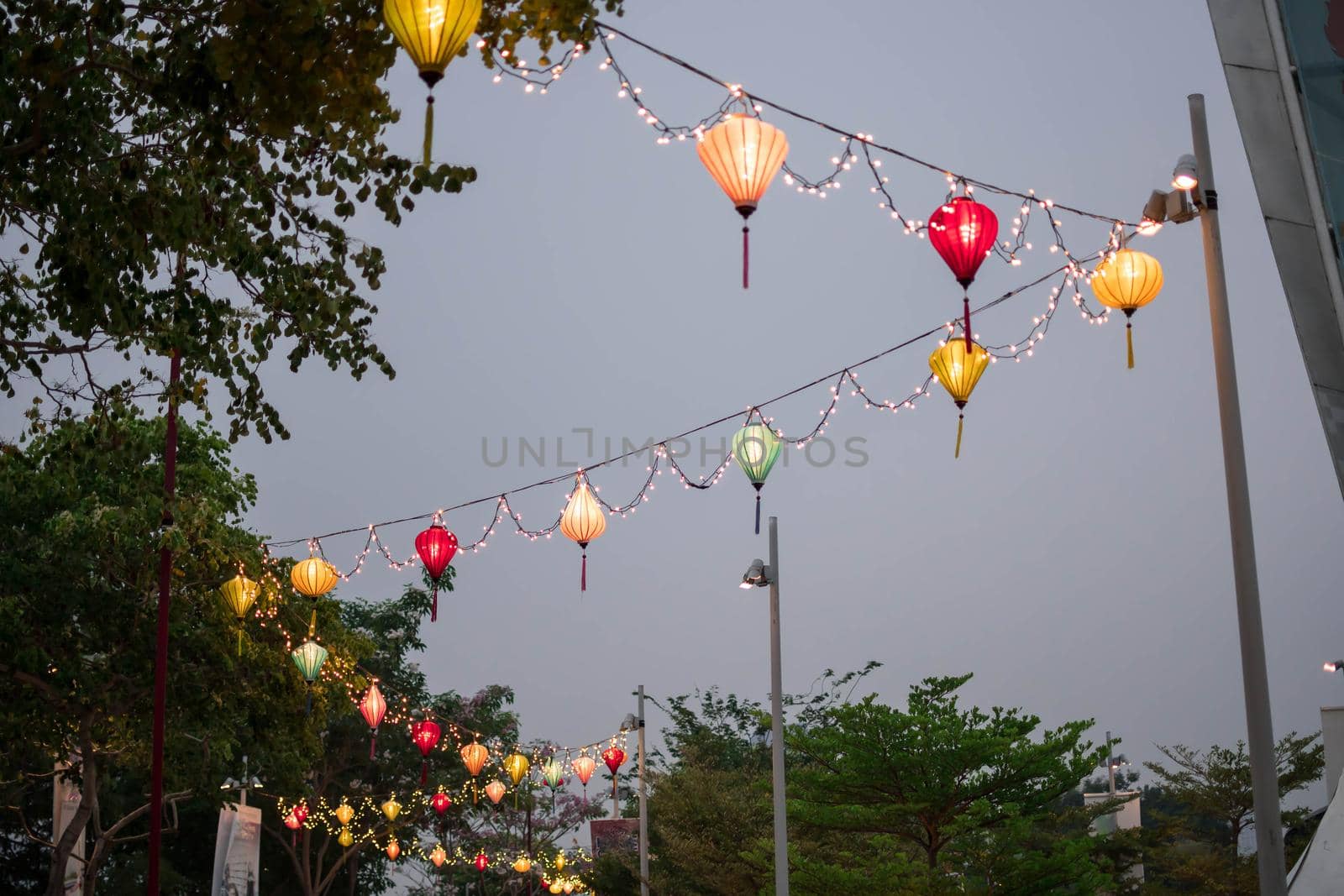Paper lanterns on the streets in Asia. Colorful lanterns hanging on streets during the Chinese lantern festival.
