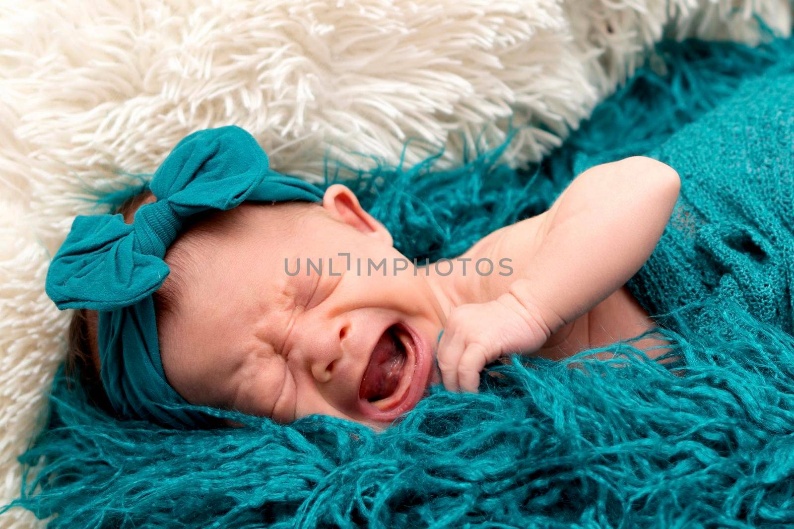 Newborn baby 2 weeks old in blue fluffy blanket  by Bonandbon