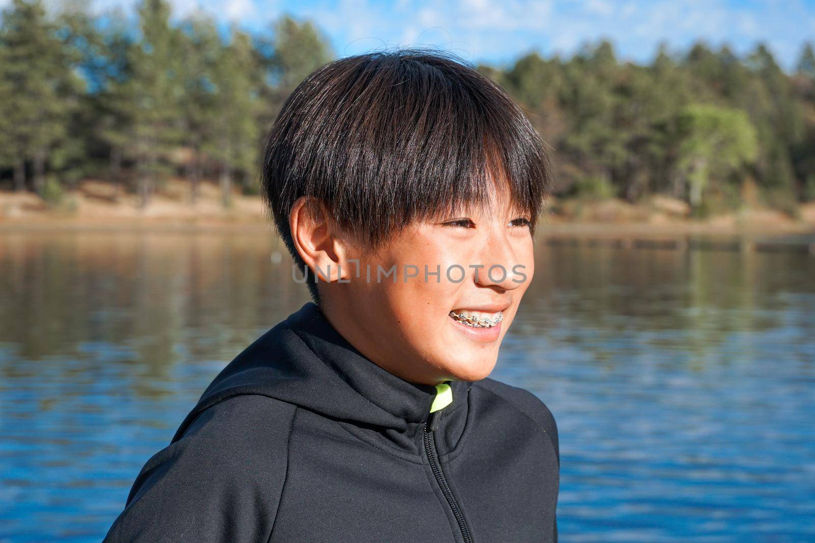 Portrait of young sporty Asian boy by the Lake by Bonandbon