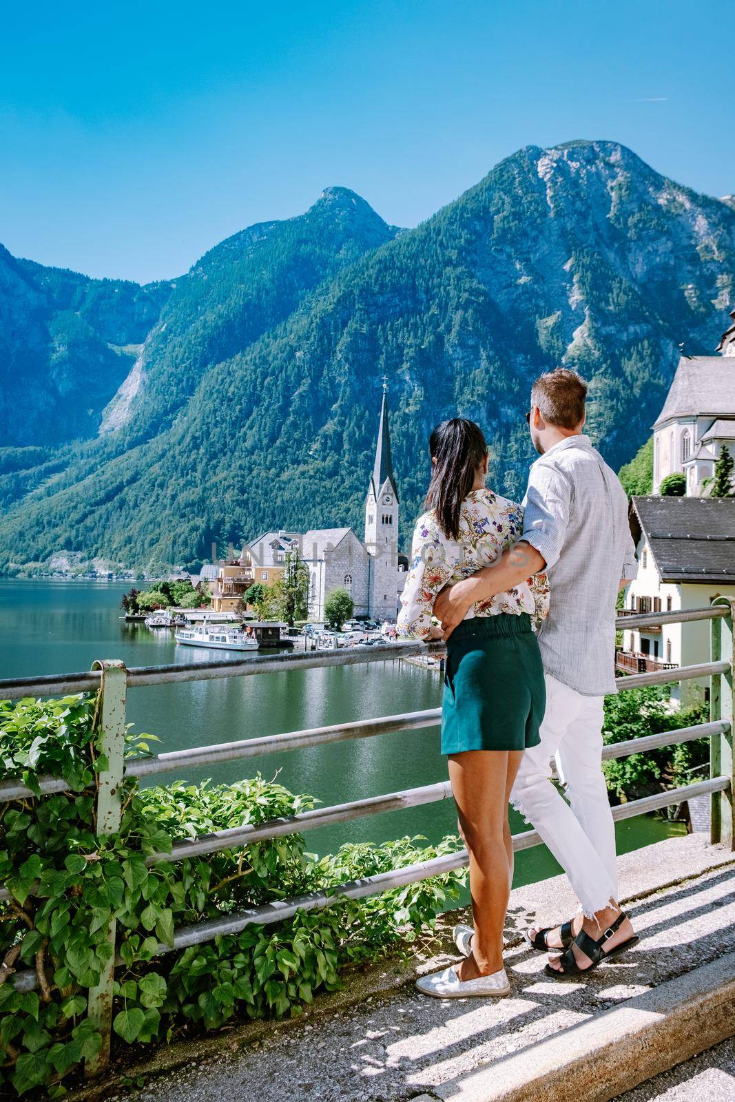 couple visit Hallstatt village on Hallstatter lake in Austrian Alps Austria by fokkebok