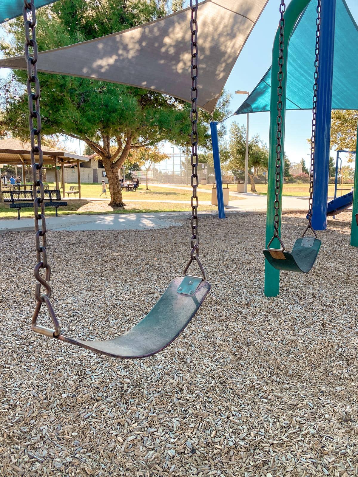 Swing at children playground activities in public park. swing on modern playground. Urban neighborhood childhood concept. 