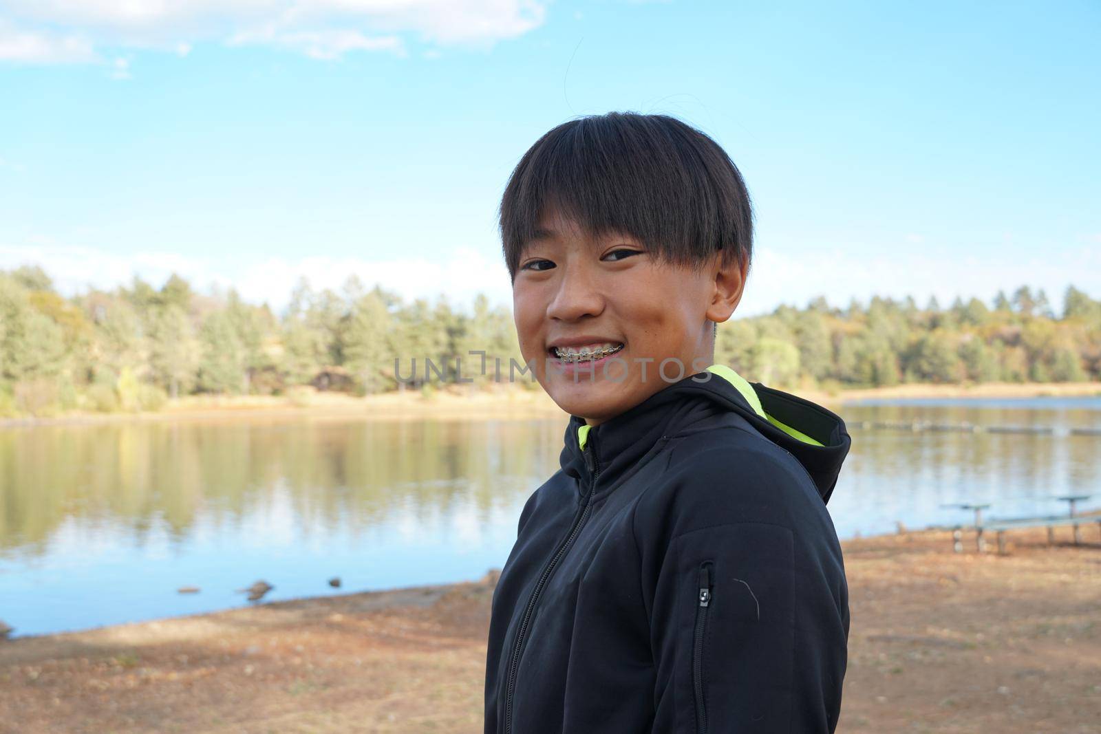 Portrait of young sporty Asian boy by the Lake by Bonandbon