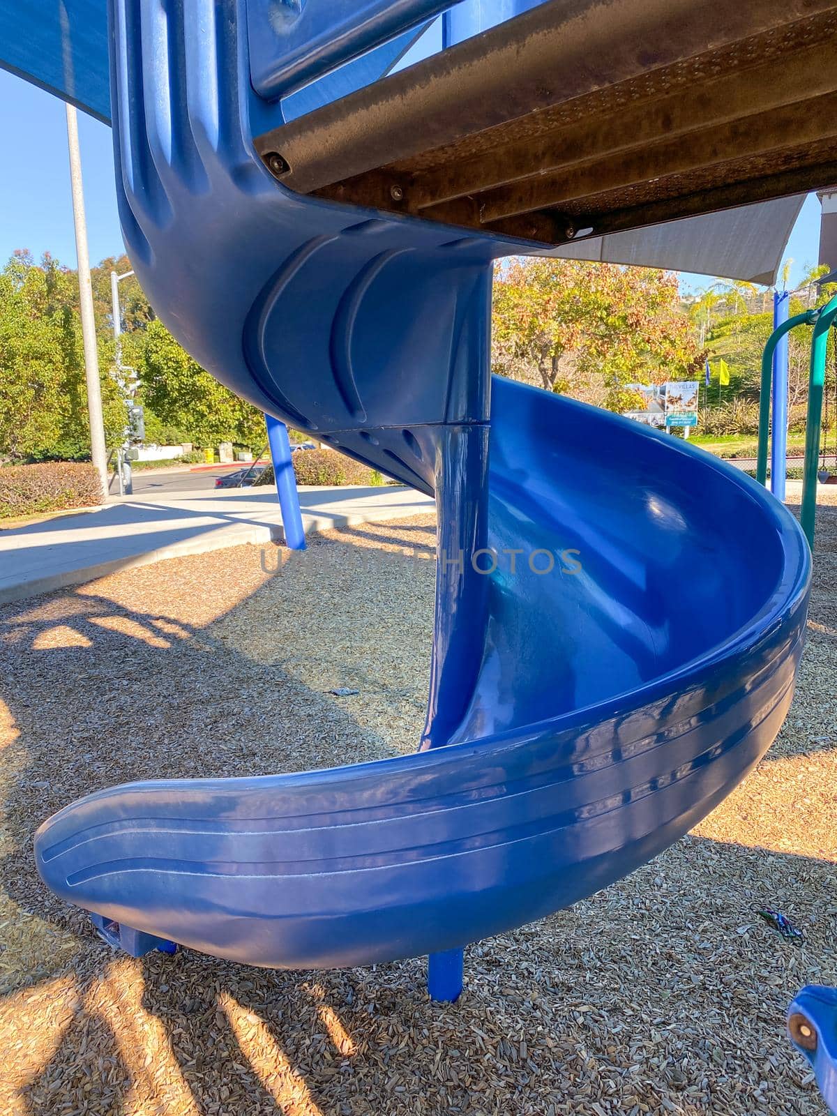 Slide at children playground activities in public park. Slide on modern playground. Urban neighborhood childhood concept. 