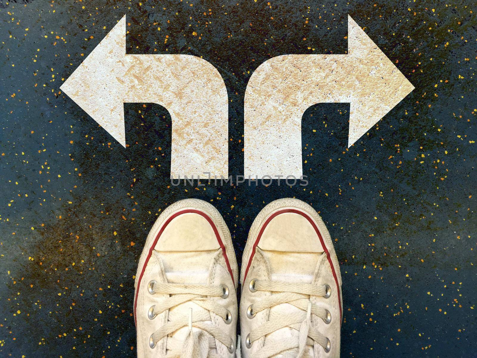 Sneakers shoes with two white arrows print pointing on grunge road , making decision business concept