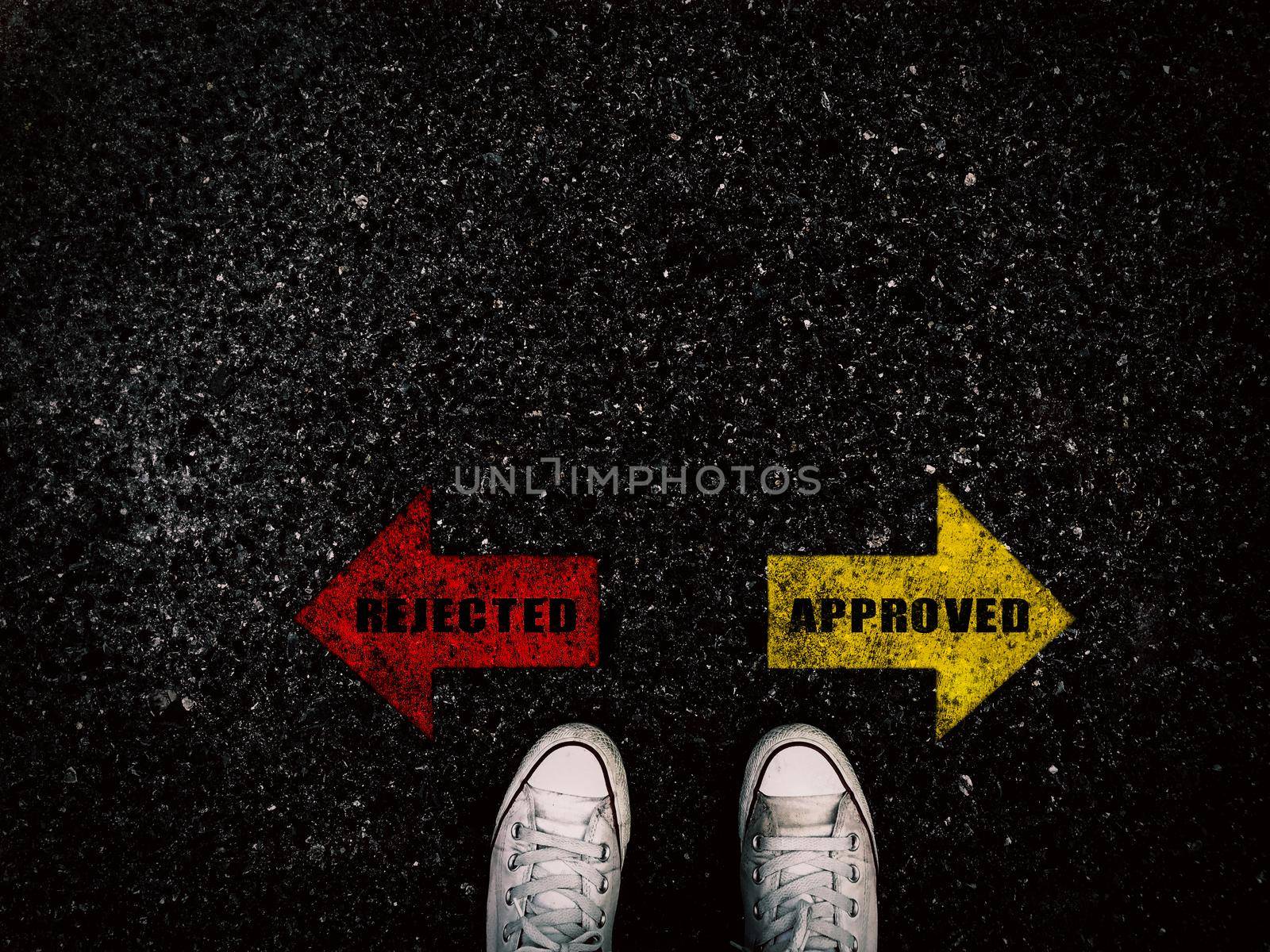 Rejected and approved red and yellow arrow on street and sneaker shoe background, business concept by Yoopho