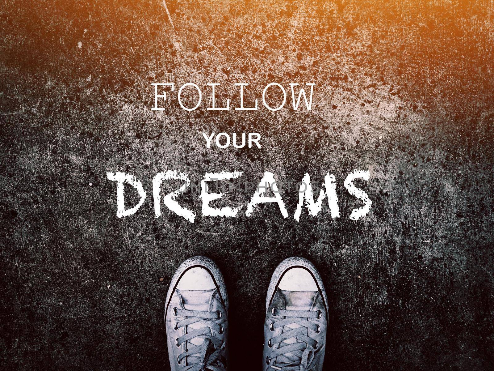 Follow your dreams word and sneakers shoes on grunge road , business concept