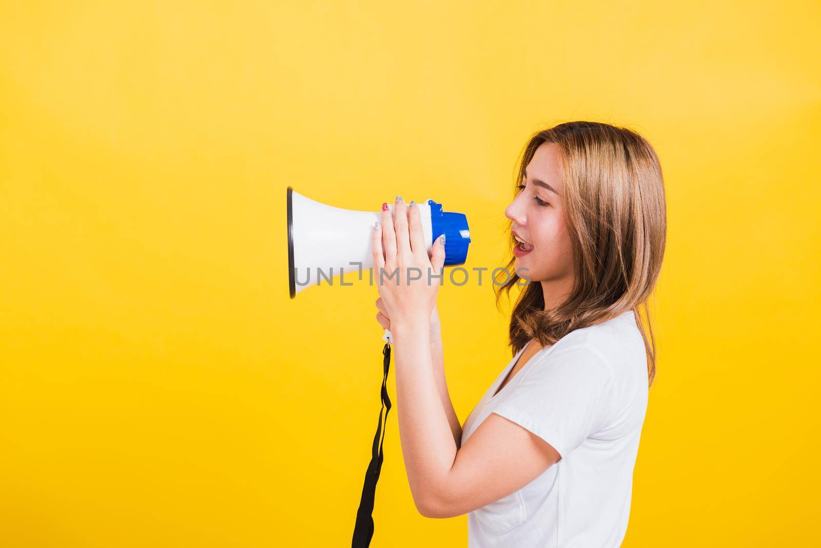 woman teen standing making announcement message shouting screaming in megaphone by Sorapop