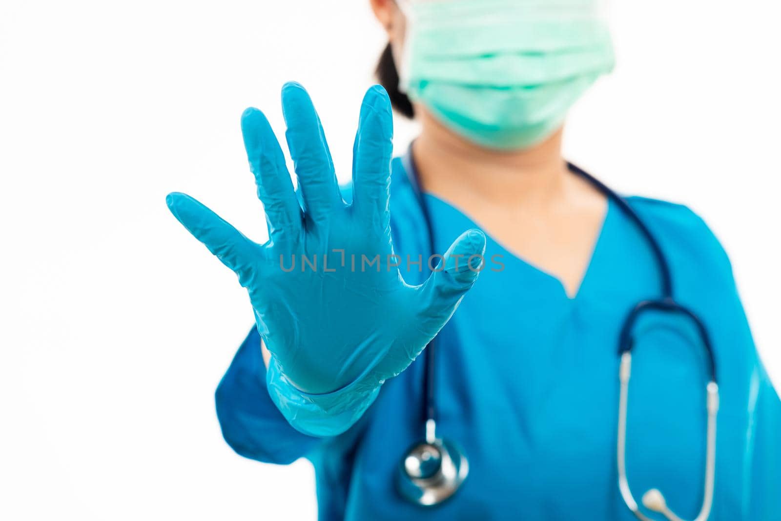 woman doctor in blue uniform show hand up stop sign by Sorapop