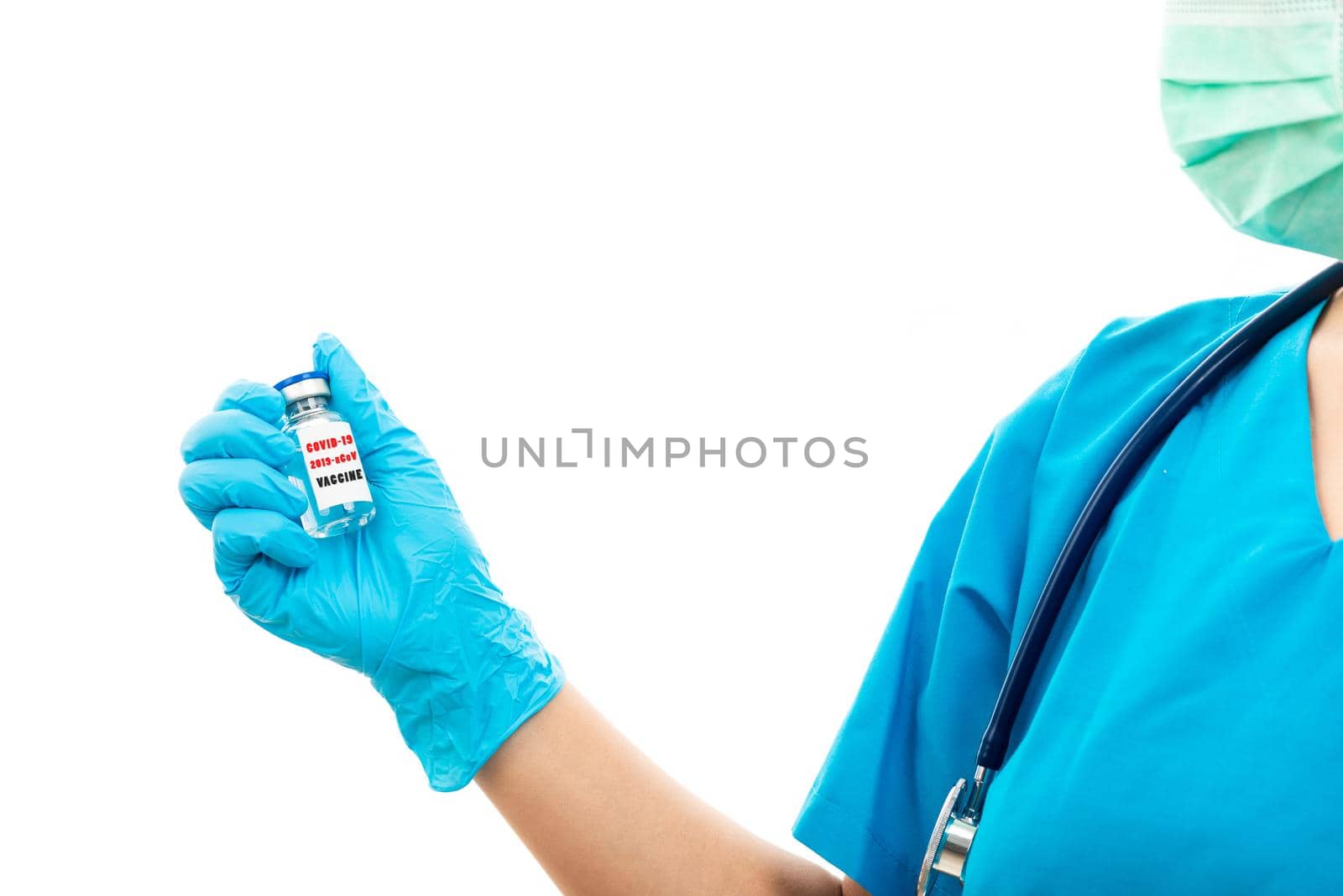 woman doctor in blue uniform holding COVID-19 vaccine by Sorapop