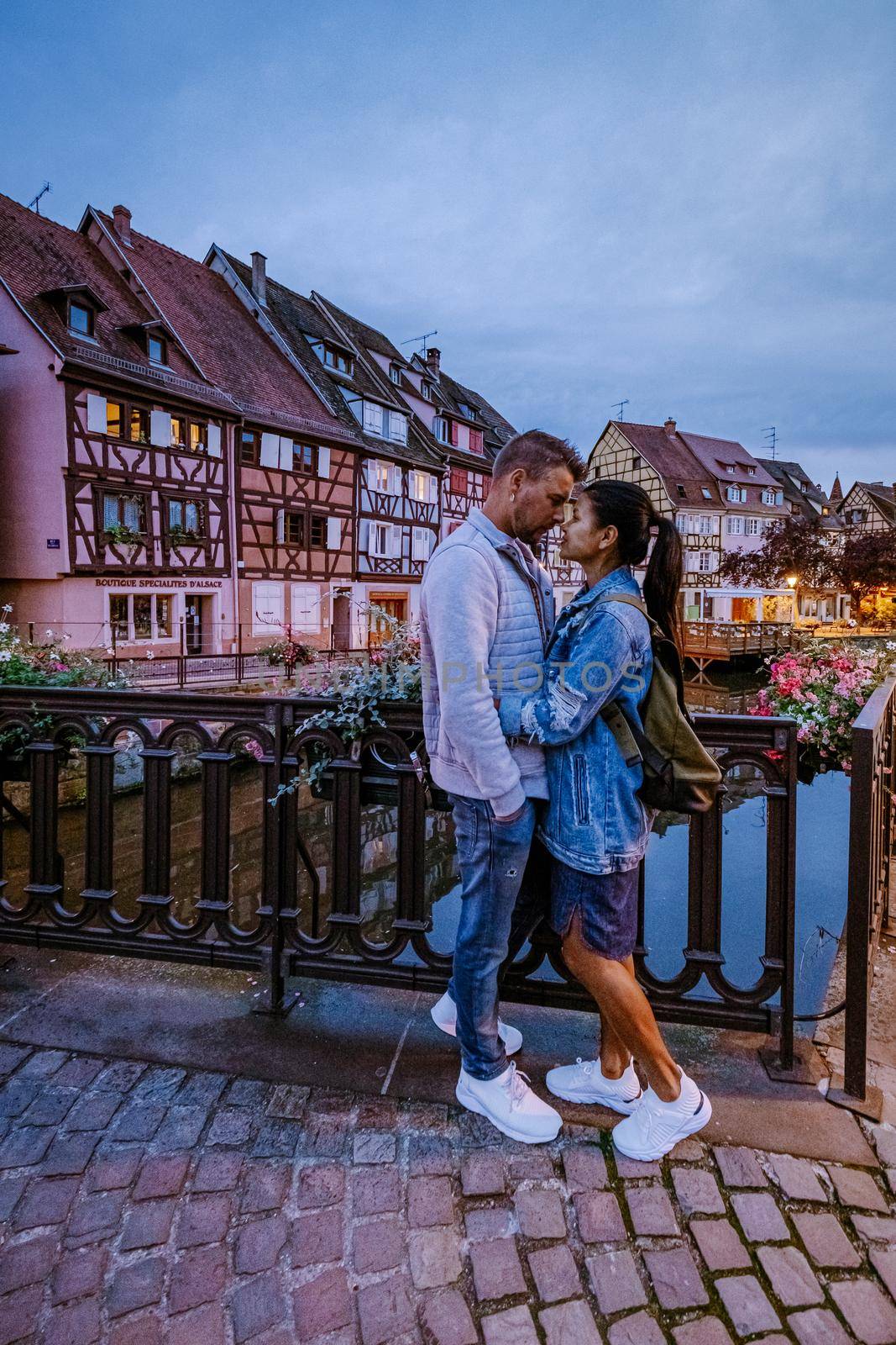 couple on city trip Colmar, Alsace, France. Petite Venice, water canal and traditional half timbered houses. Colmar is a charming town in Alsace, France. Beautiful view of colorful romantic city Colmar, France, Alsace by fokkebok