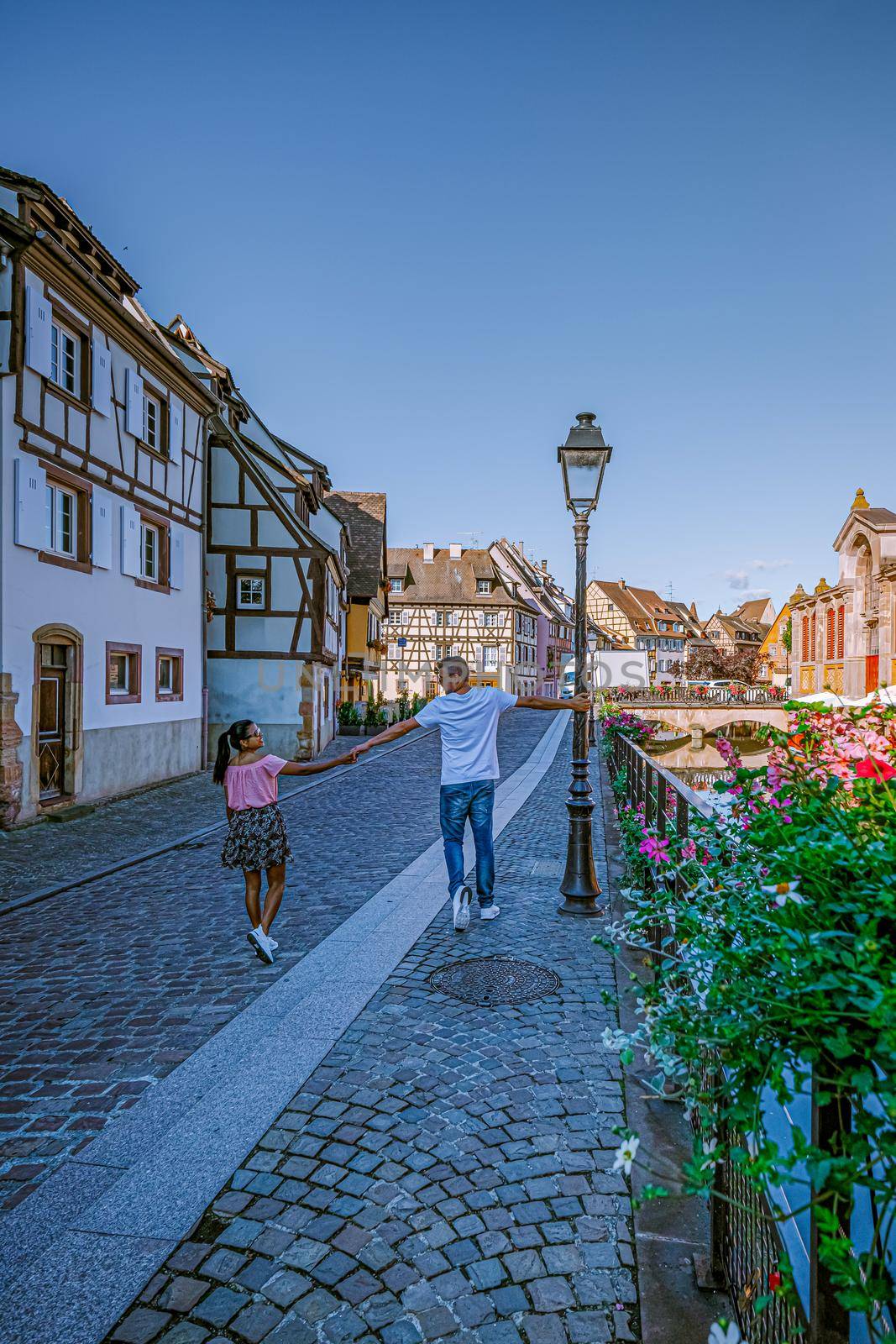 couple on city trip Colmar, Alsace, France. Petite Venice, water canal and traditional half timbered houses. Colmar is a charming town in Alsace, France. Beautiful view of colorful romantic city Colmar