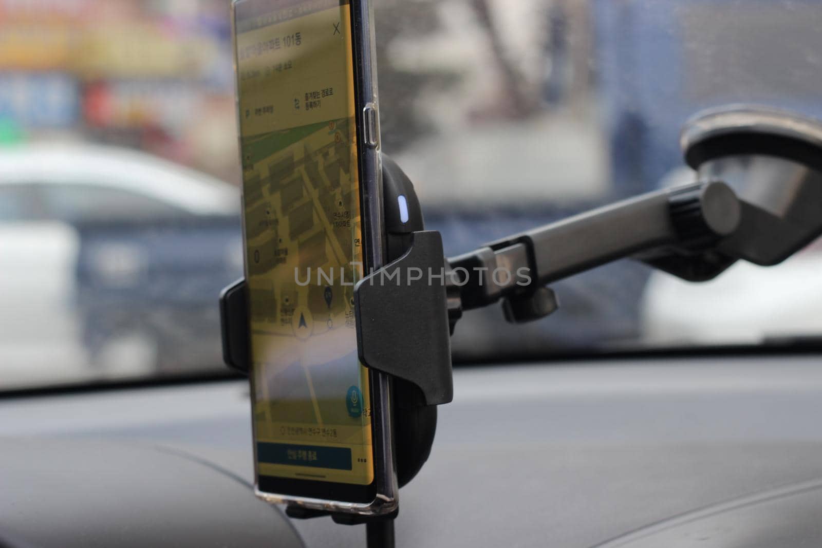 Smart phone holder attached to windscreen of car by Photochowk