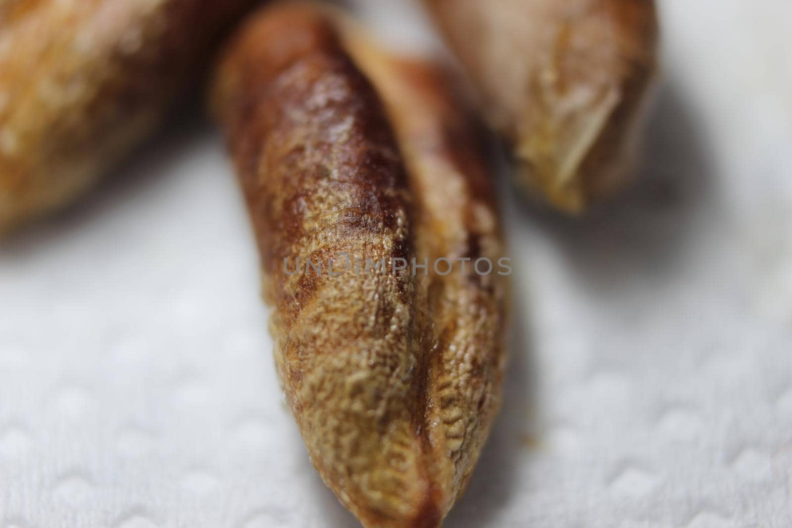 Date or palm seeds isolated on white background. Macro photograph of date seeds