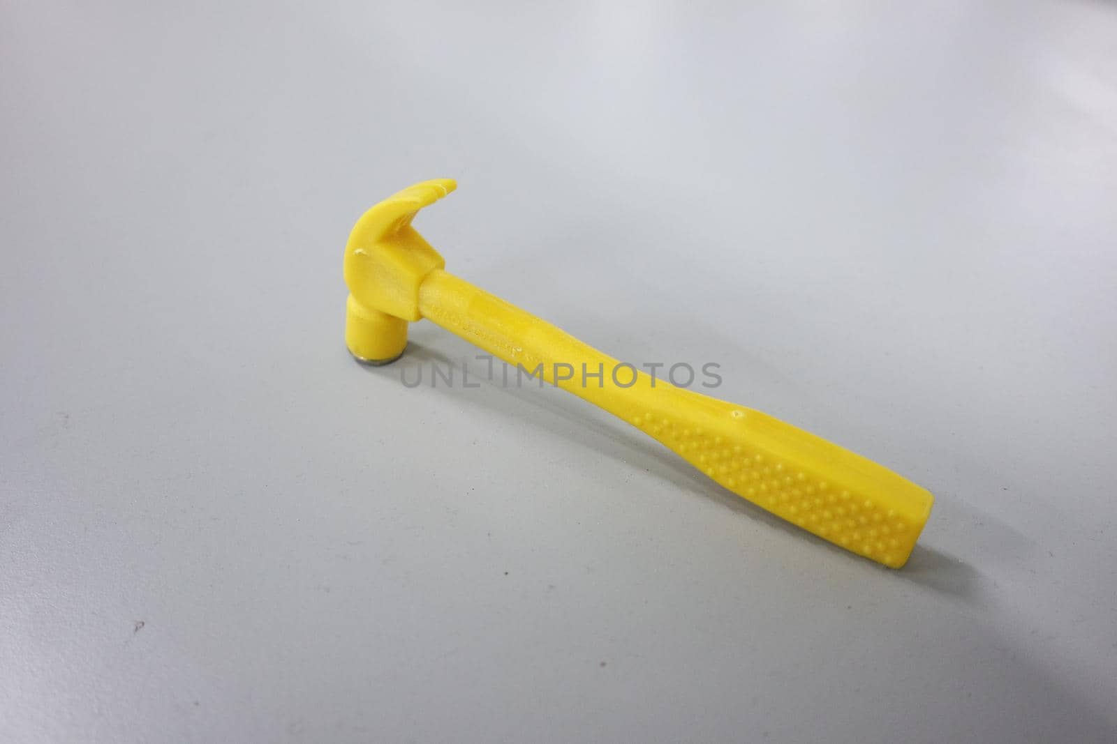 Selective focused, closeup view of toy hammer made from plastic by Photochowk