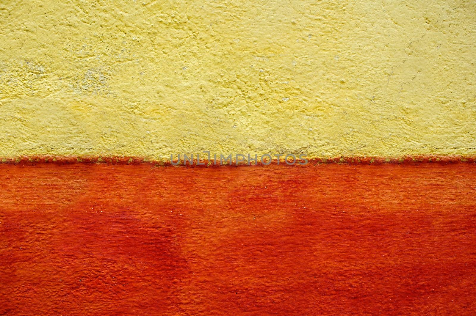 Horizontally two-tone plastered wall of yellow-orange color.Texture or background