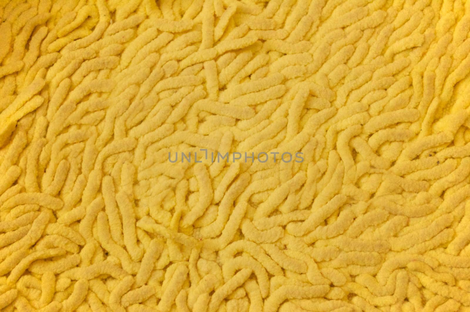 Big yellow highlighted with a textured surface Mat for the bathroom.Texture or background