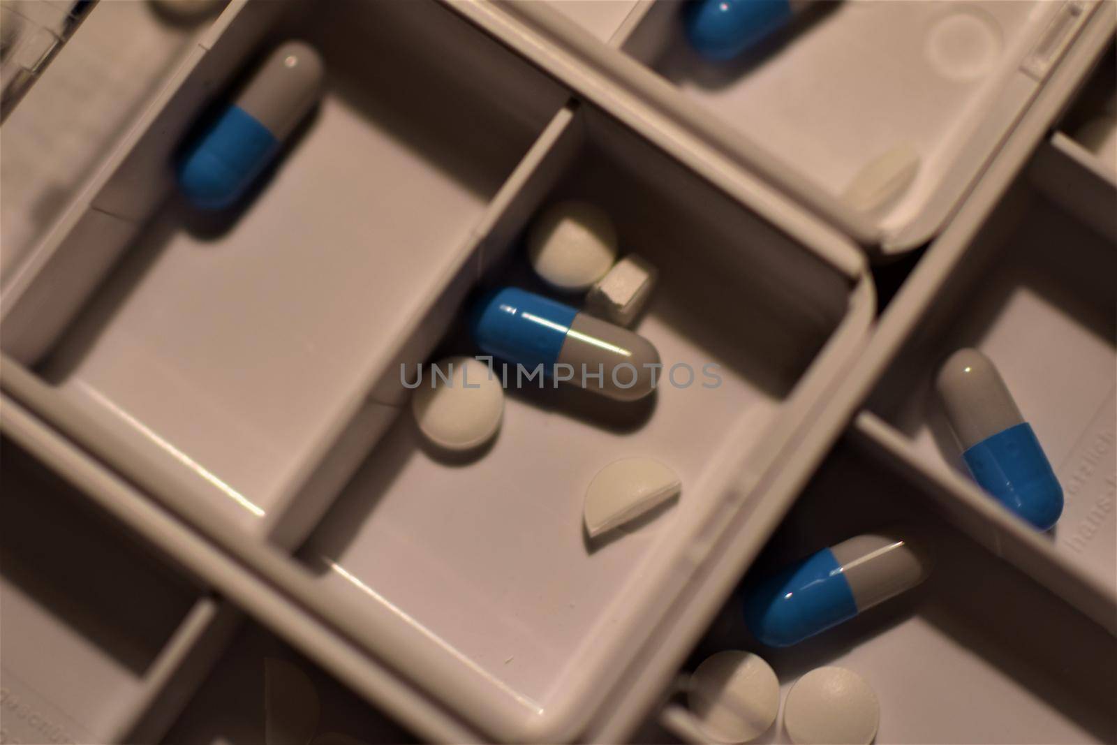 Close-up of different pills prepared in tablets boxes