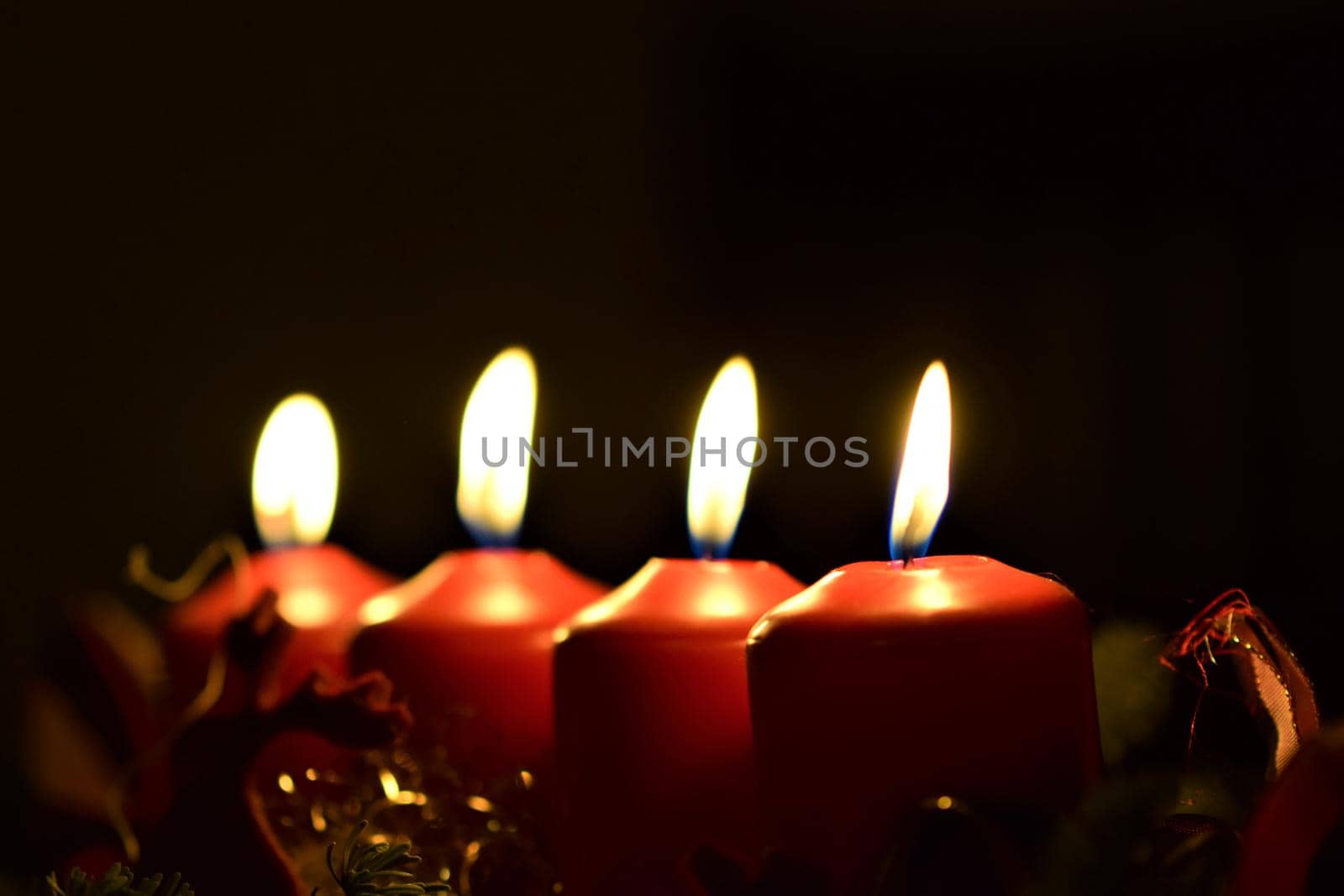 close-up of an Advent arrangement with 4 burning candles