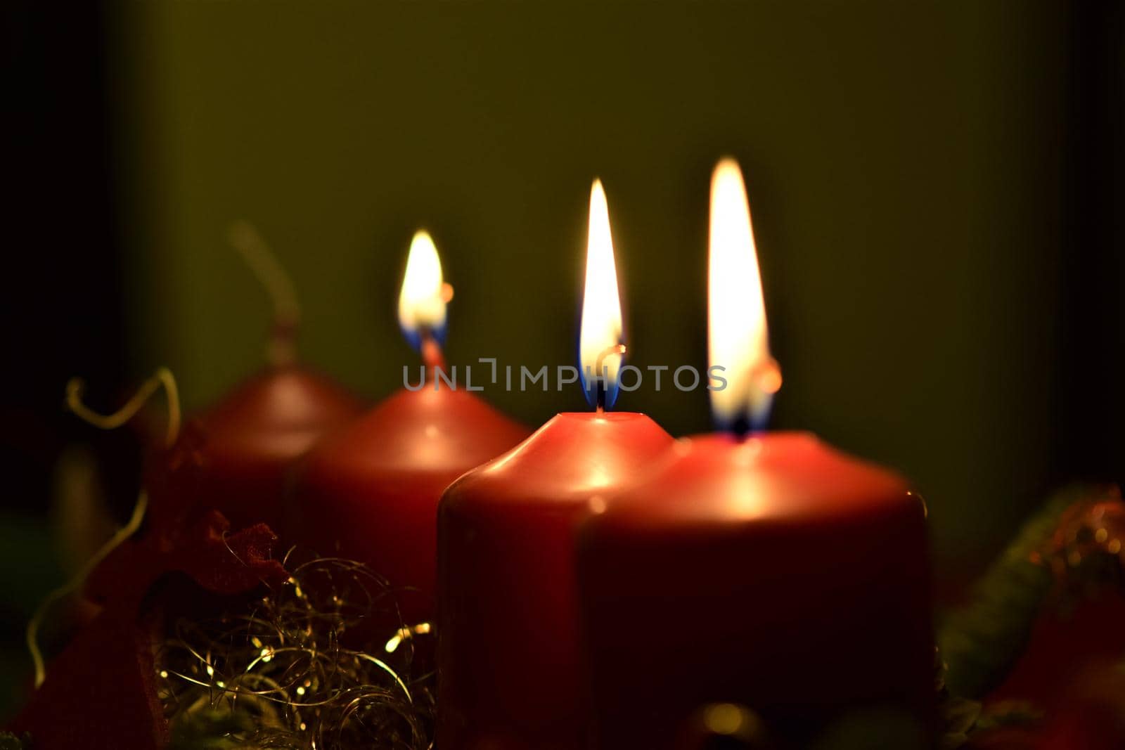 close-up of an Advent arrangement with 3 burning candles