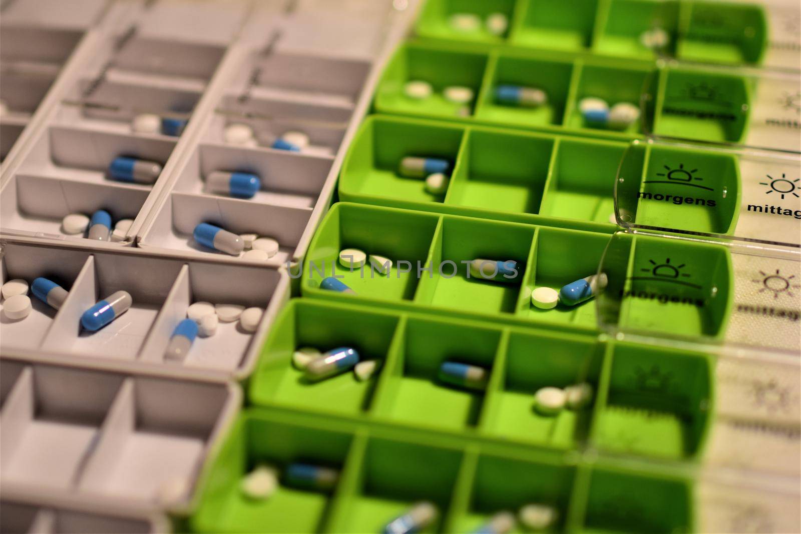 Close-up of different pills prepared in tablets boxes