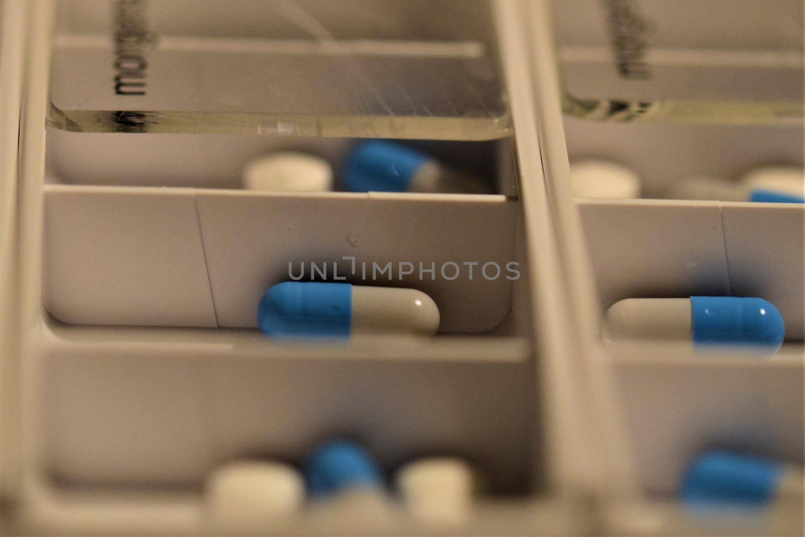 Close-up of different pills prepared in tablets boxes