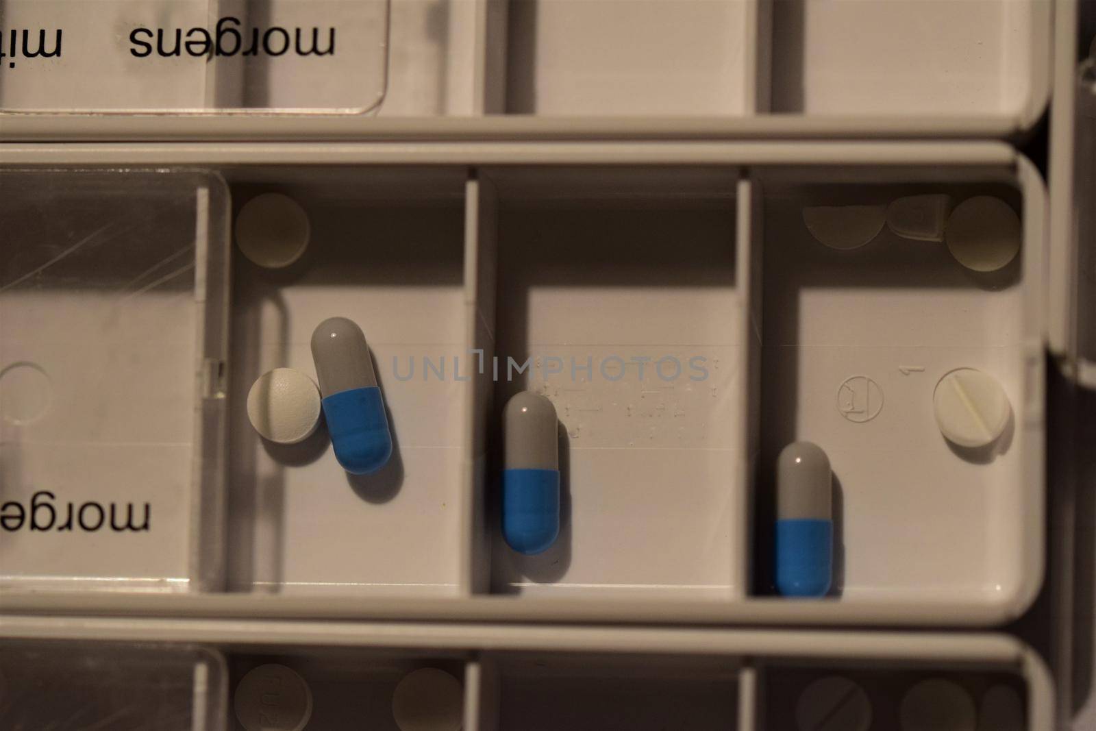 Close-up of different pills prepared in tablets boxes