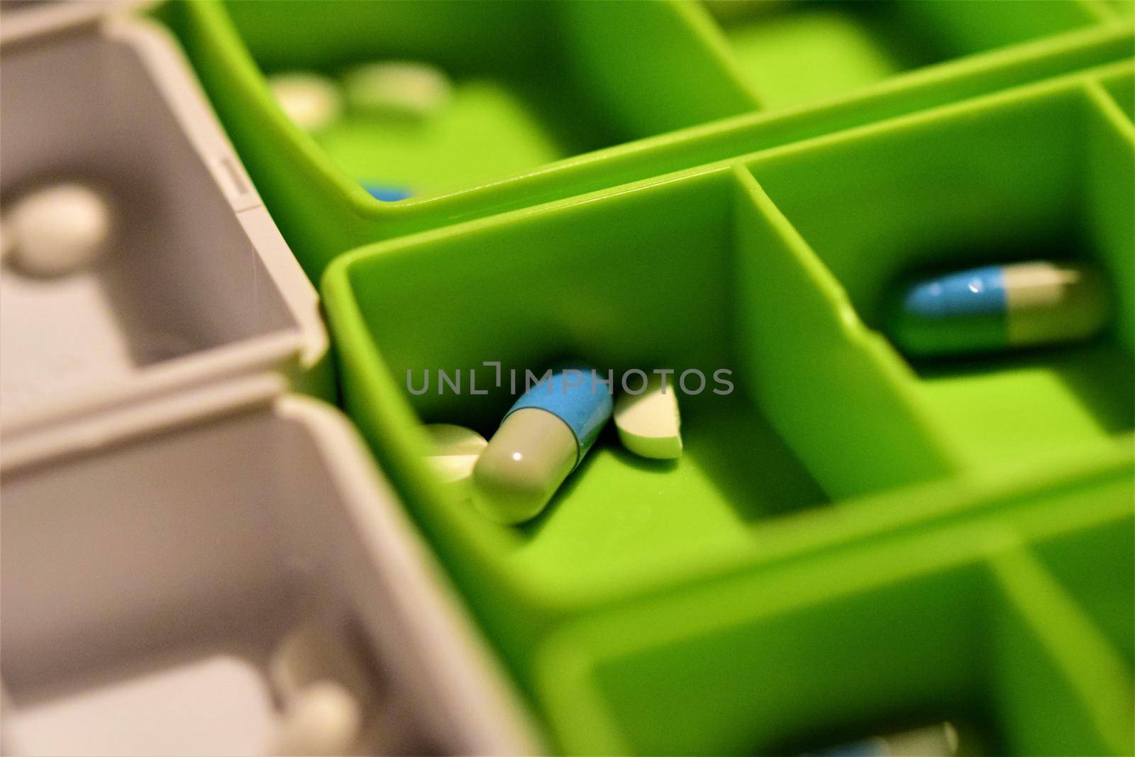 Close-up of different pills prepared in tablets boxes
