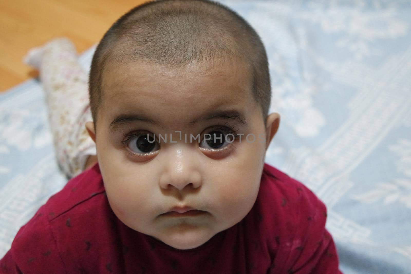 Baby girl with lovely face, big eyes and cute face gesture. Toddler baby making sweet activities