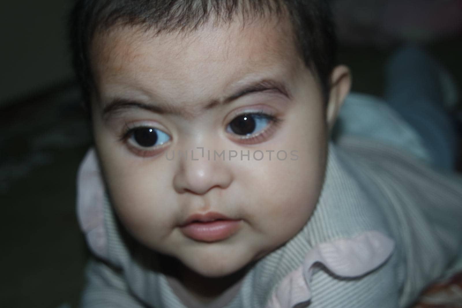 Baby girl with lovely face, big eyes and cute face gesture. Toddler baby making sweet activities