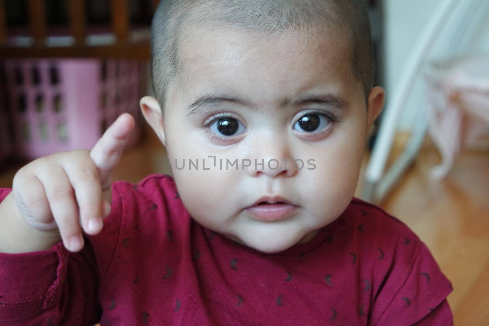 Baby girl with lovely face, big eyes and cute face gesture. Toddler baby making sweet activities