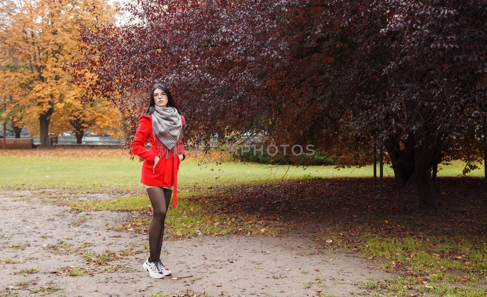 young girl in a red coat standing on the alley by raddnatt