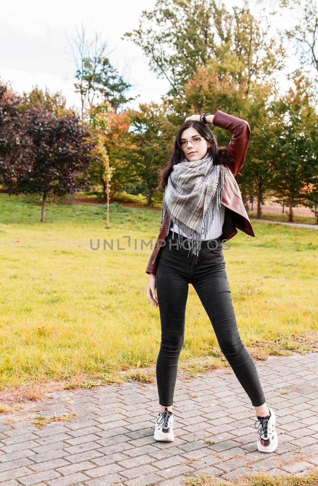 young girl standing on the alley in city park by raddnatt