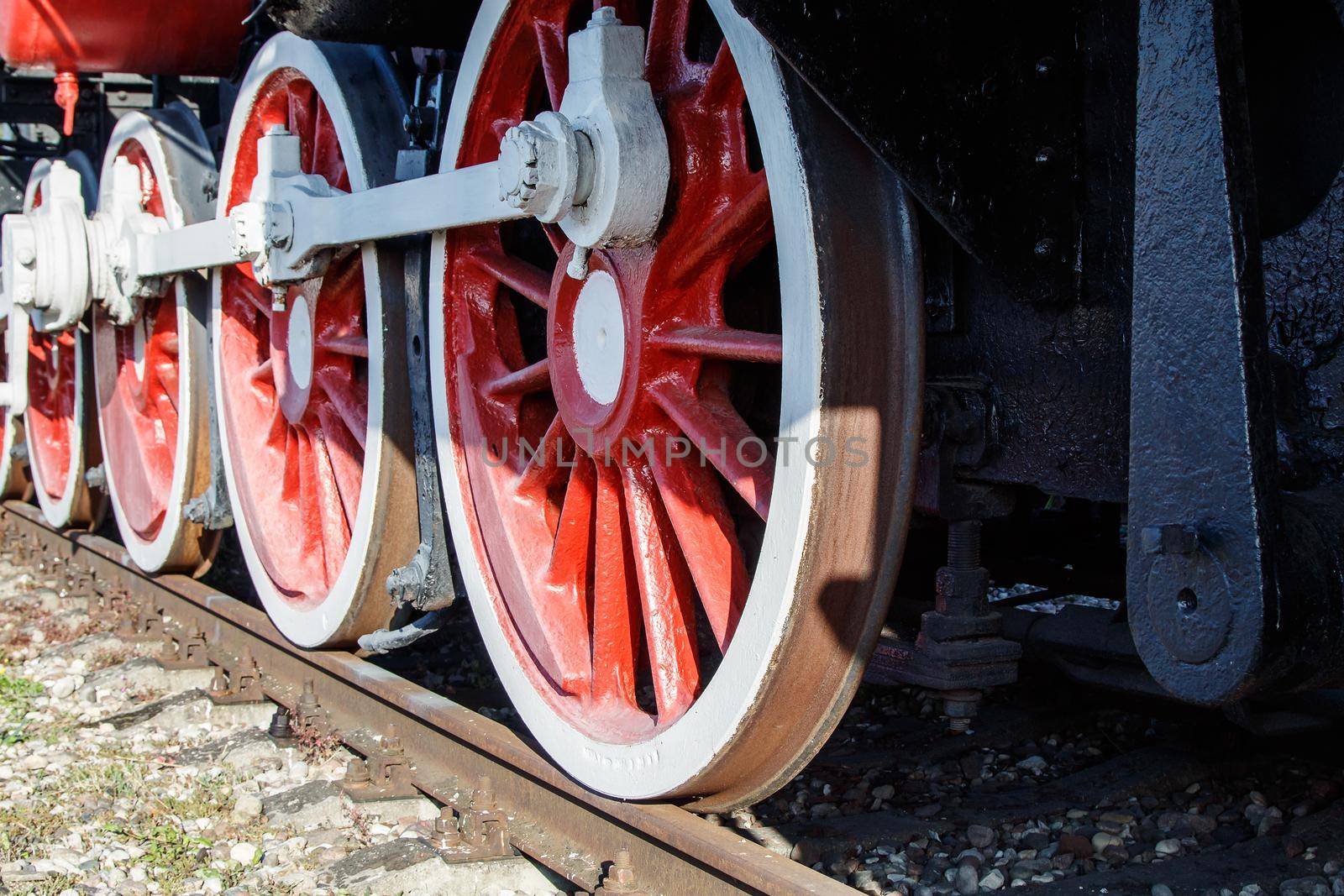 old vintage locomotive wheels closeup outdoor on sunny day